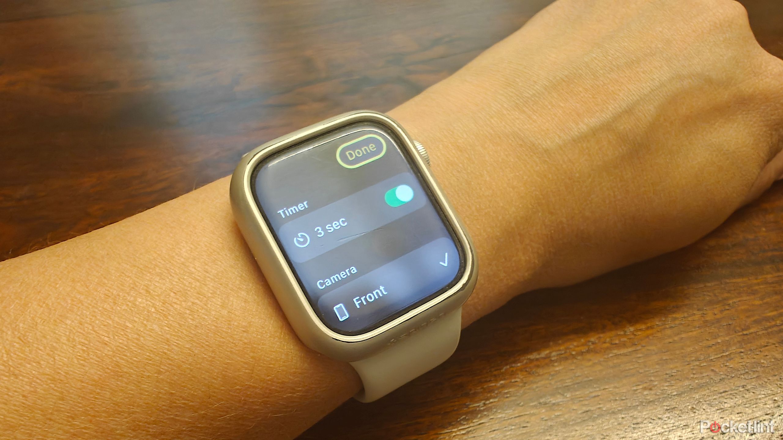 Apple Watch on an arm showing the camera trigger with a timer.