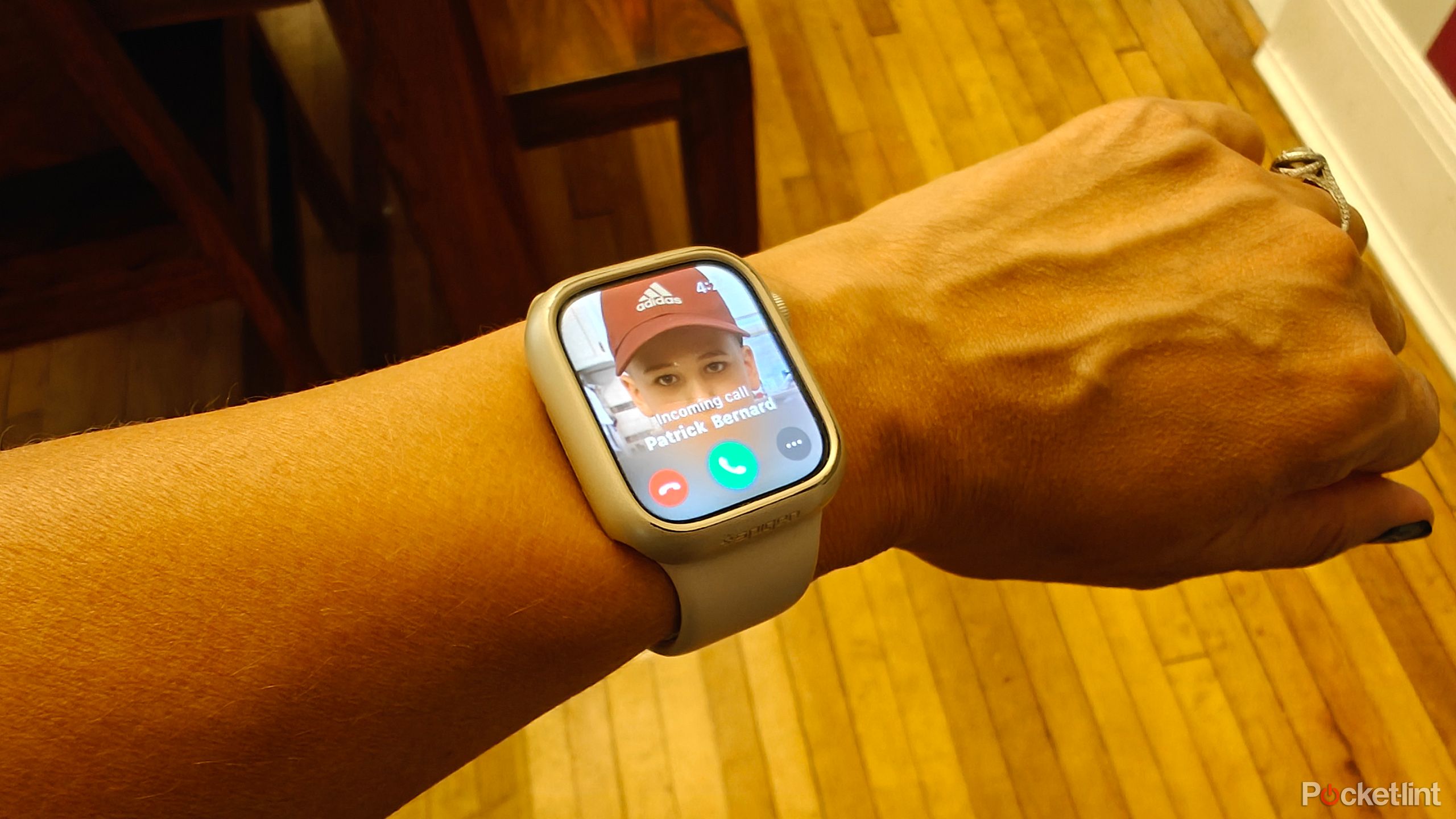 An Apple Watch on wrist showing an incoming call