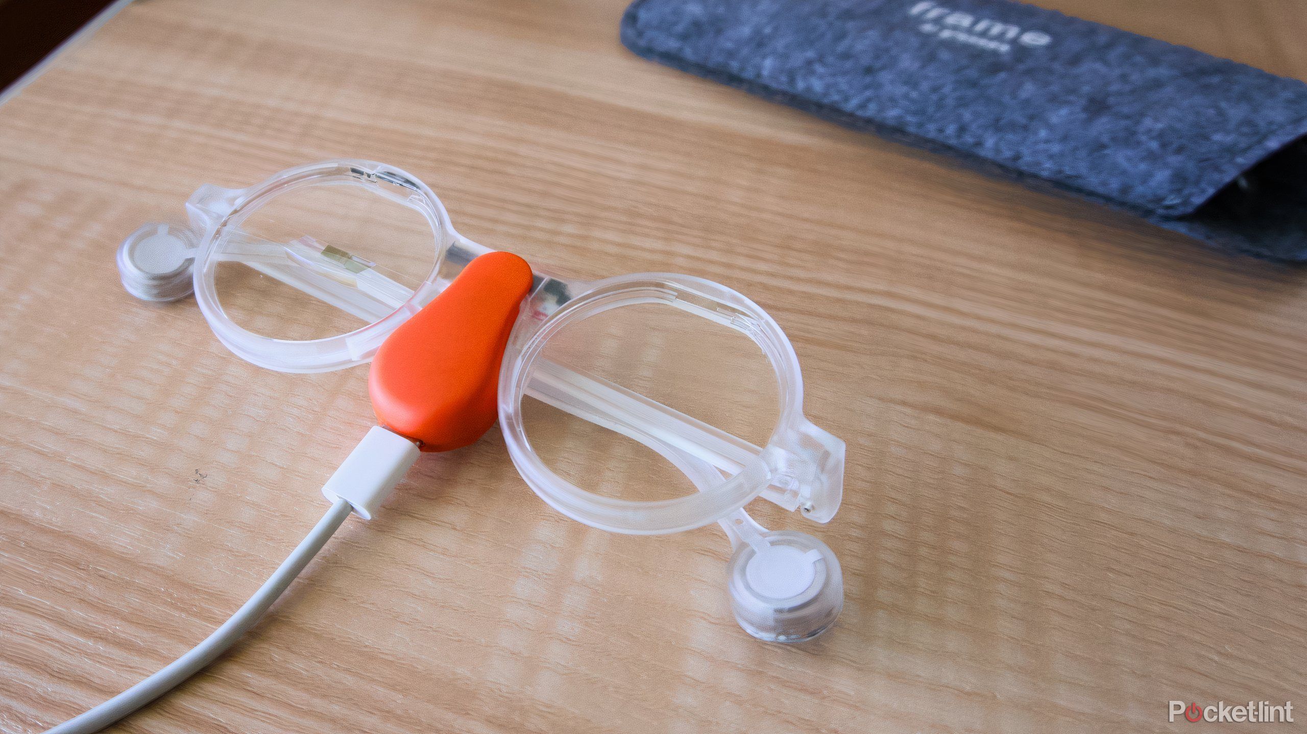 The Frame glasses charging on a orange Mister Power charger.