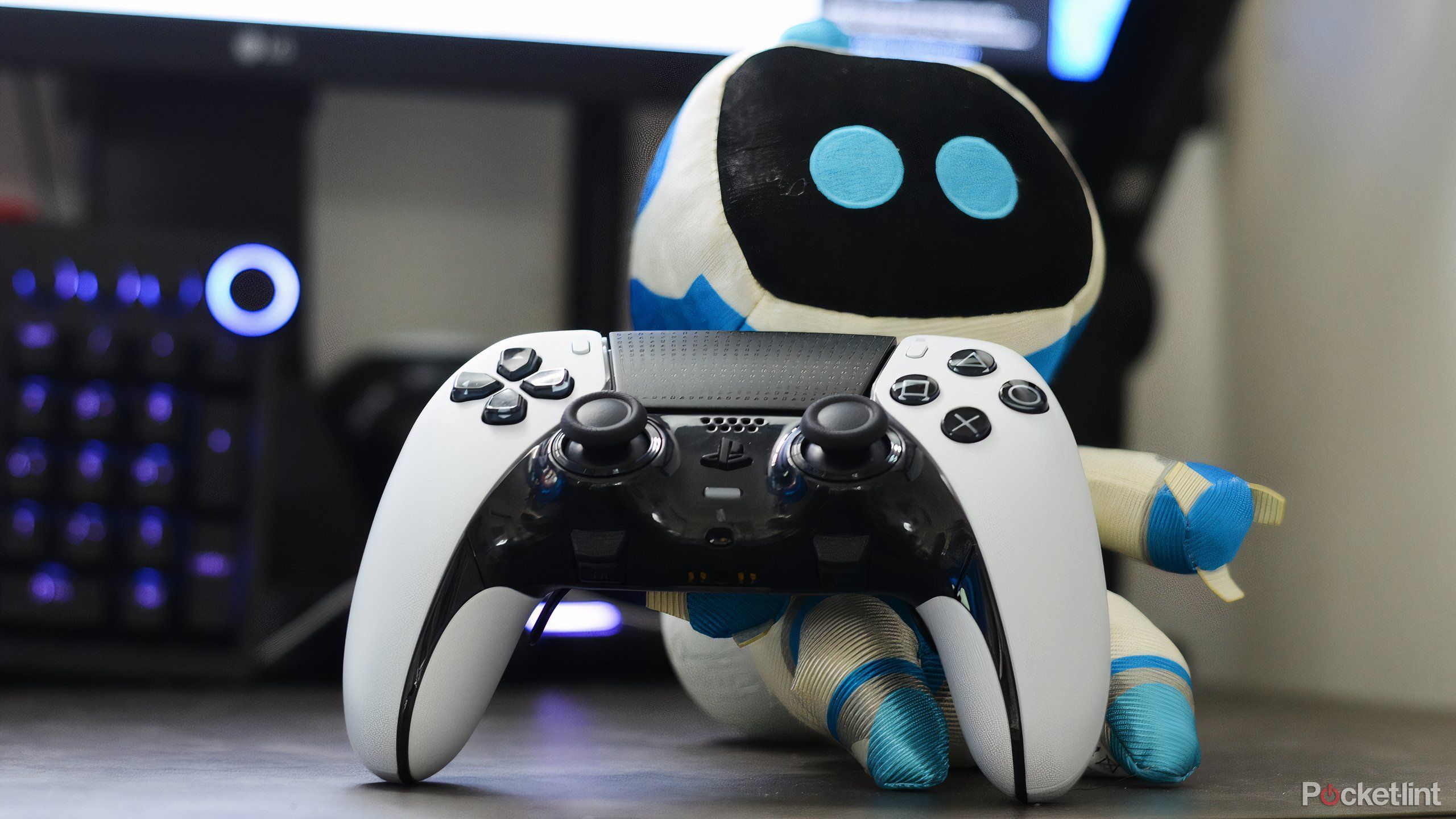 Astro bot plushie beside a PlayStation controller