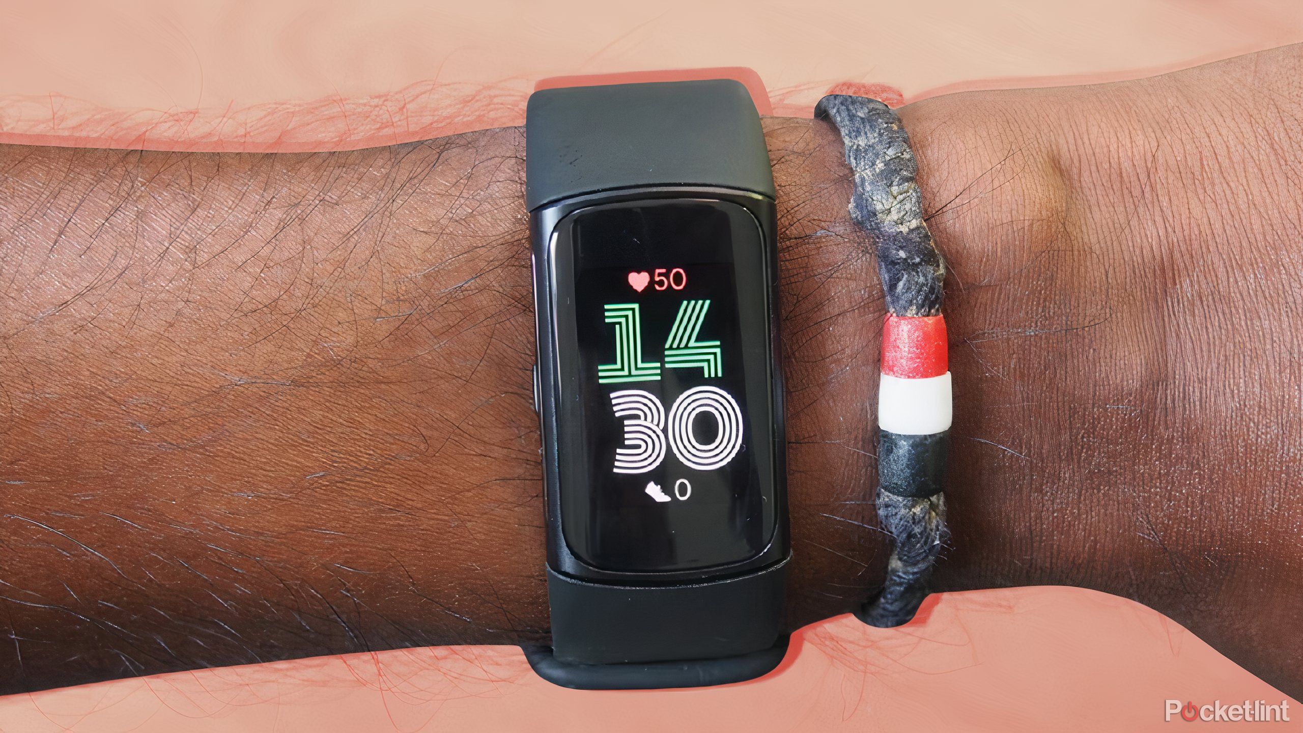 A black Fitbit Charge 6 on a orange background.