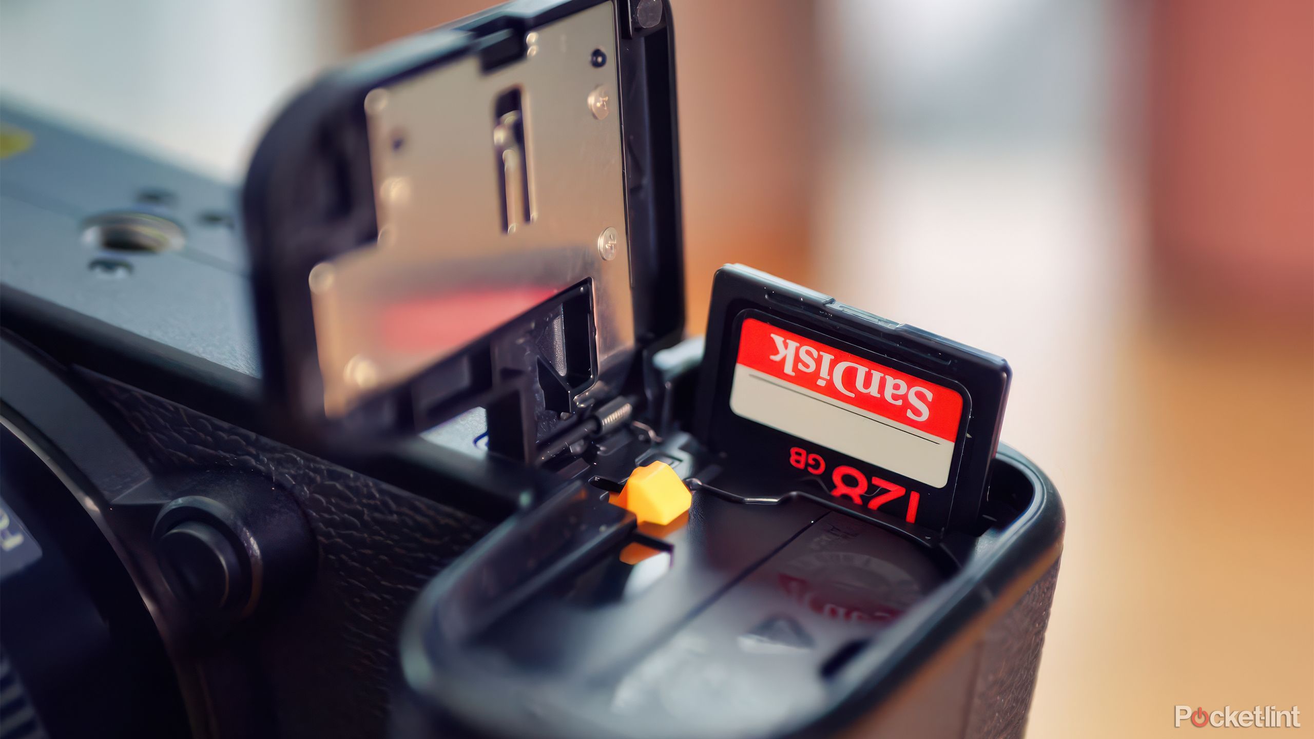 A memory card protrudes from the slot on the Fujifilm X-S20.