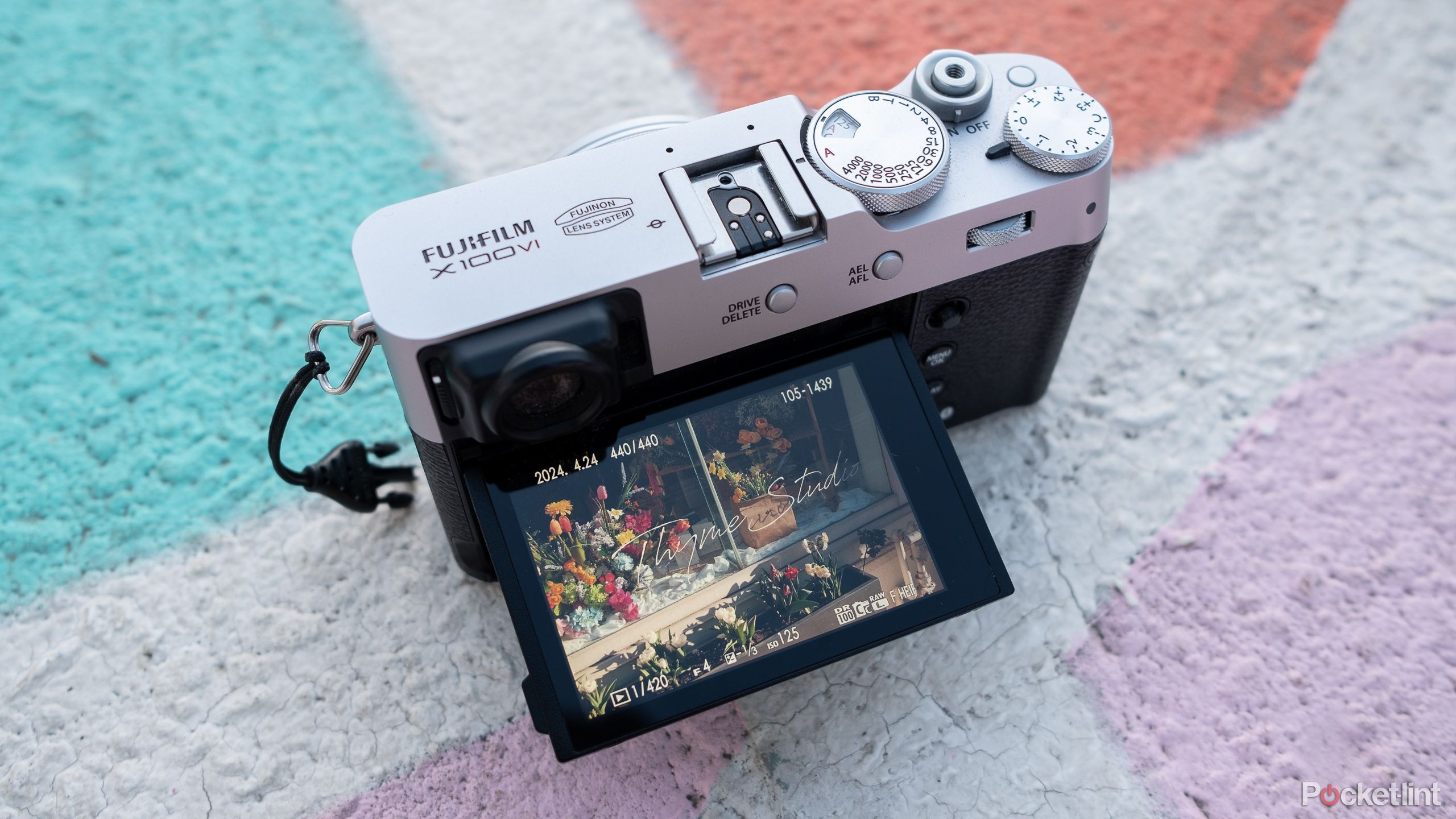 The X100VI sits on a painted basketball court