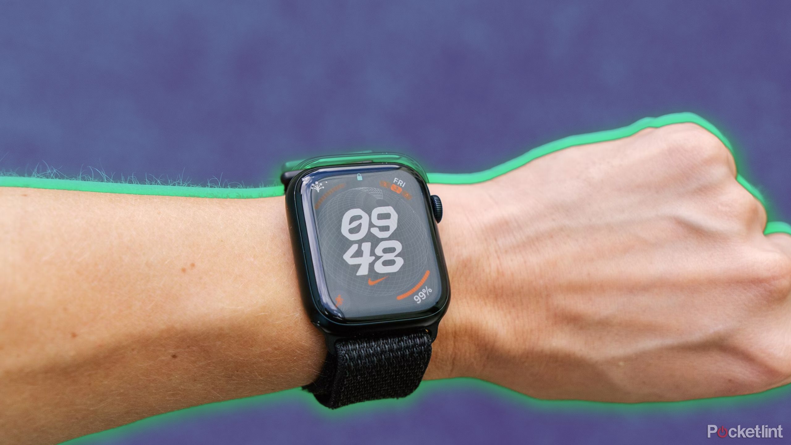 The Apple Watch on a wrist in front of a blurred blue background. 