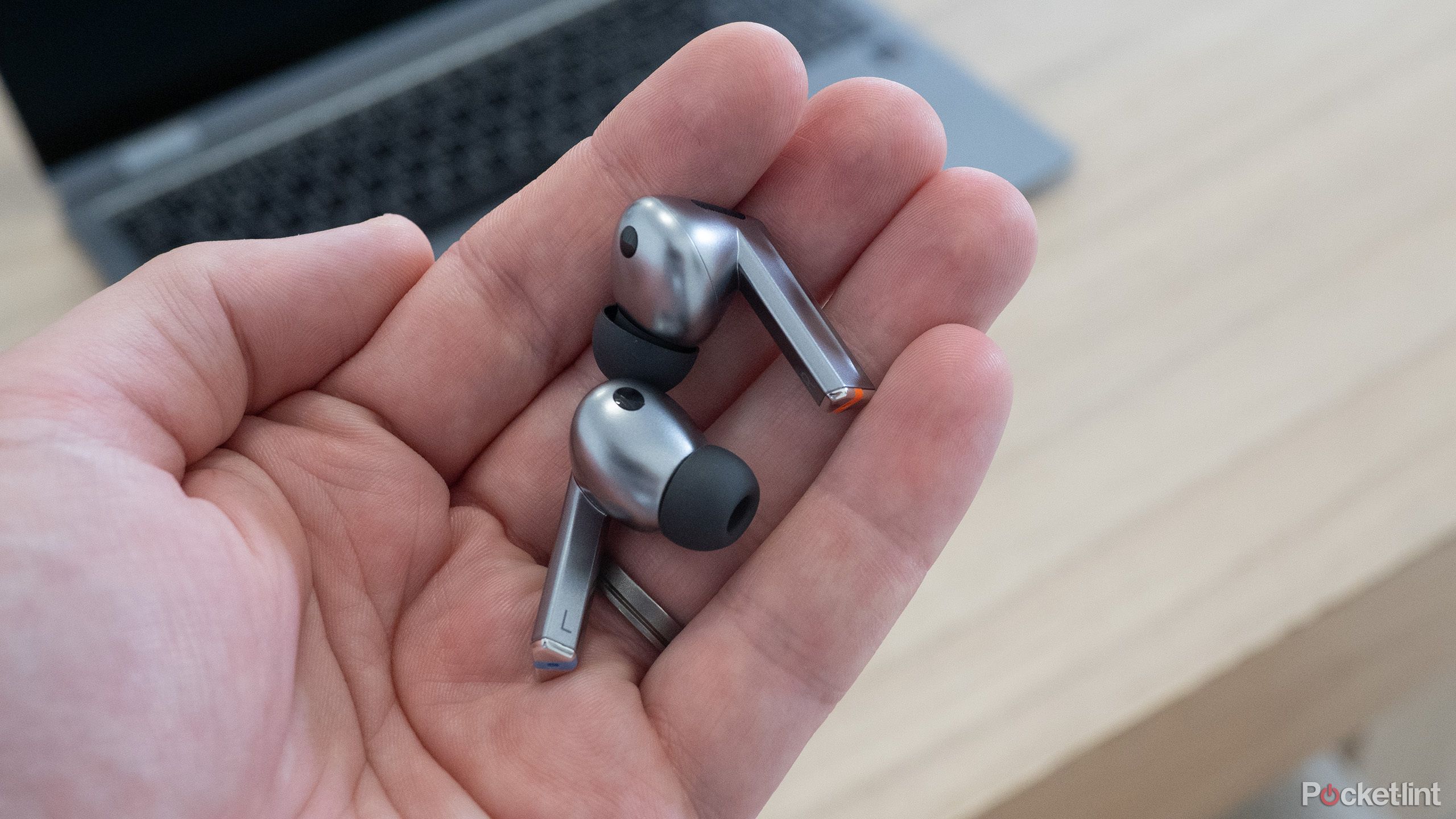 The Samsung Galaxy Buds 3 Pro earbuds being held in a hand.
