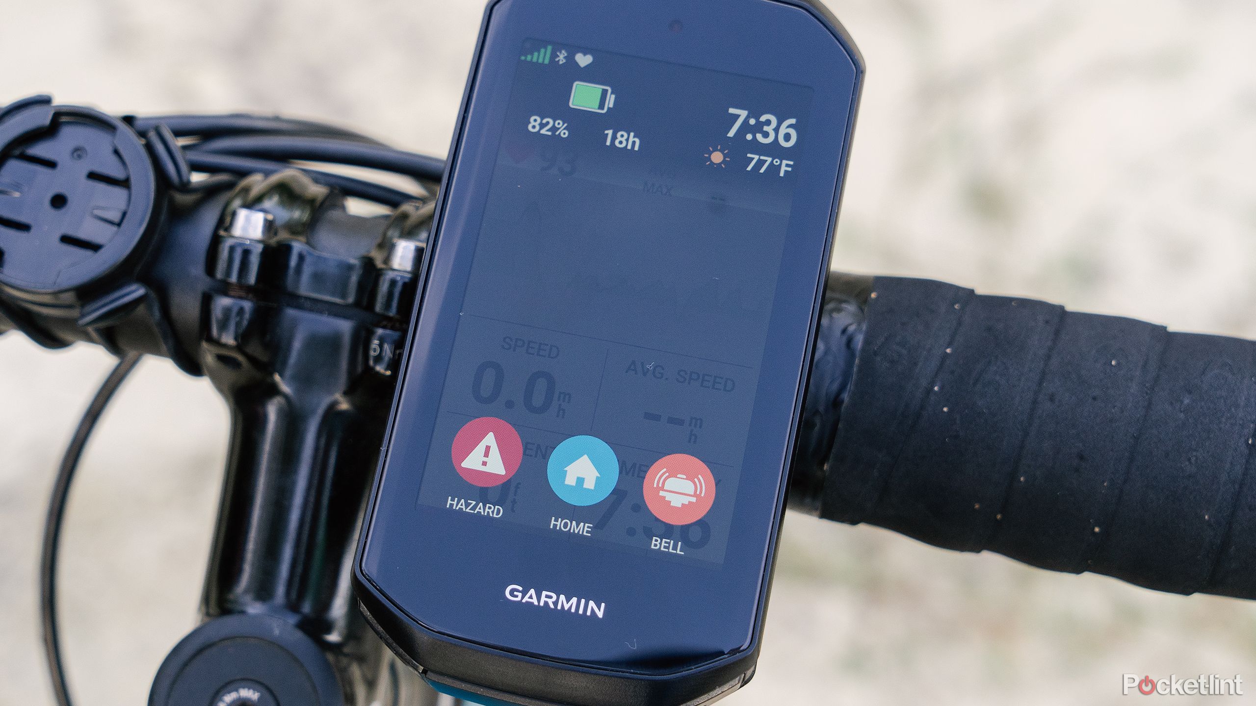 The Garmin Edge 1050 displays the bike bell and hazard screen while mounted to handlebars.