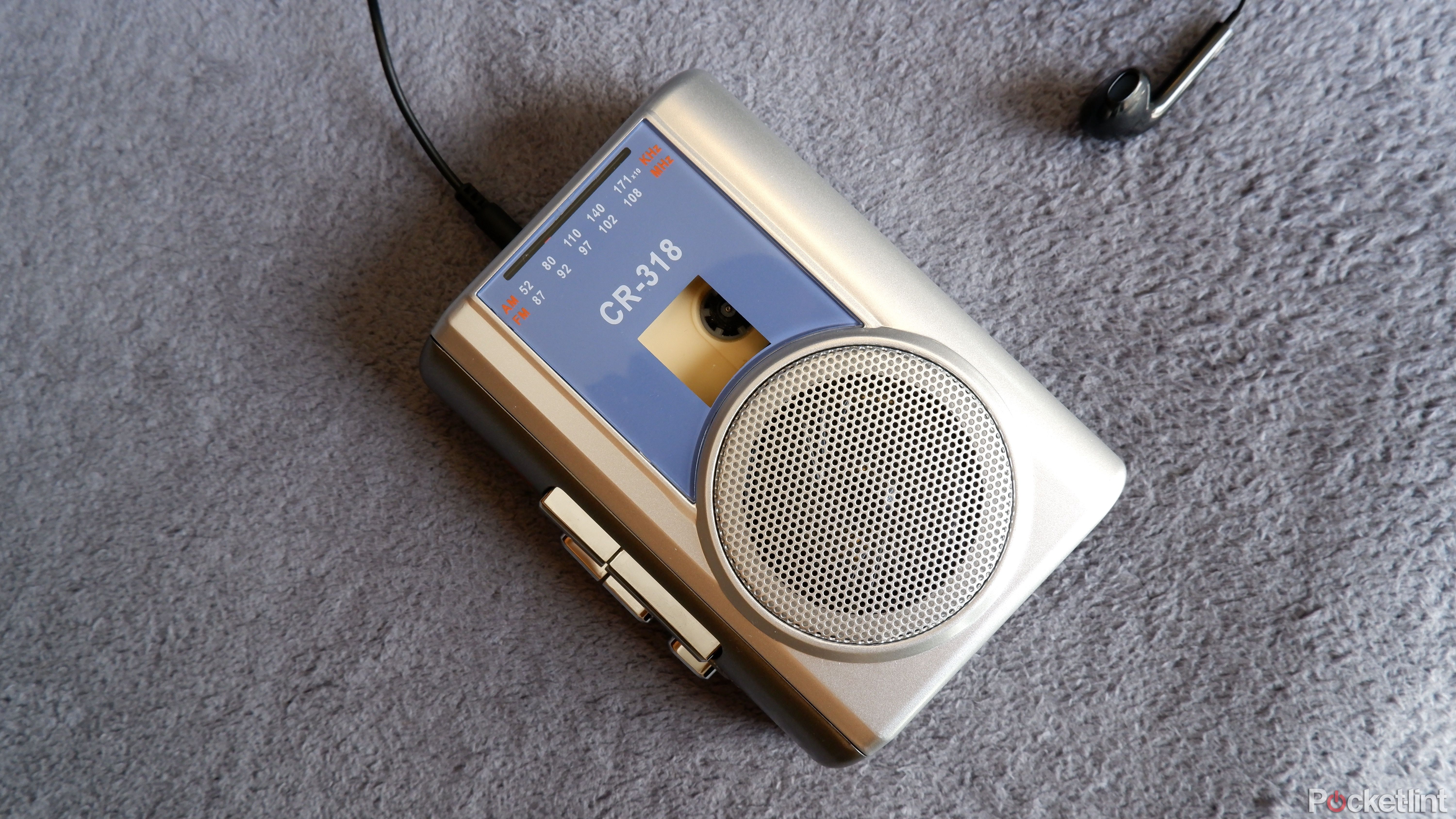 The Gracioso cassette player on a blue blanket with headphones plugged in