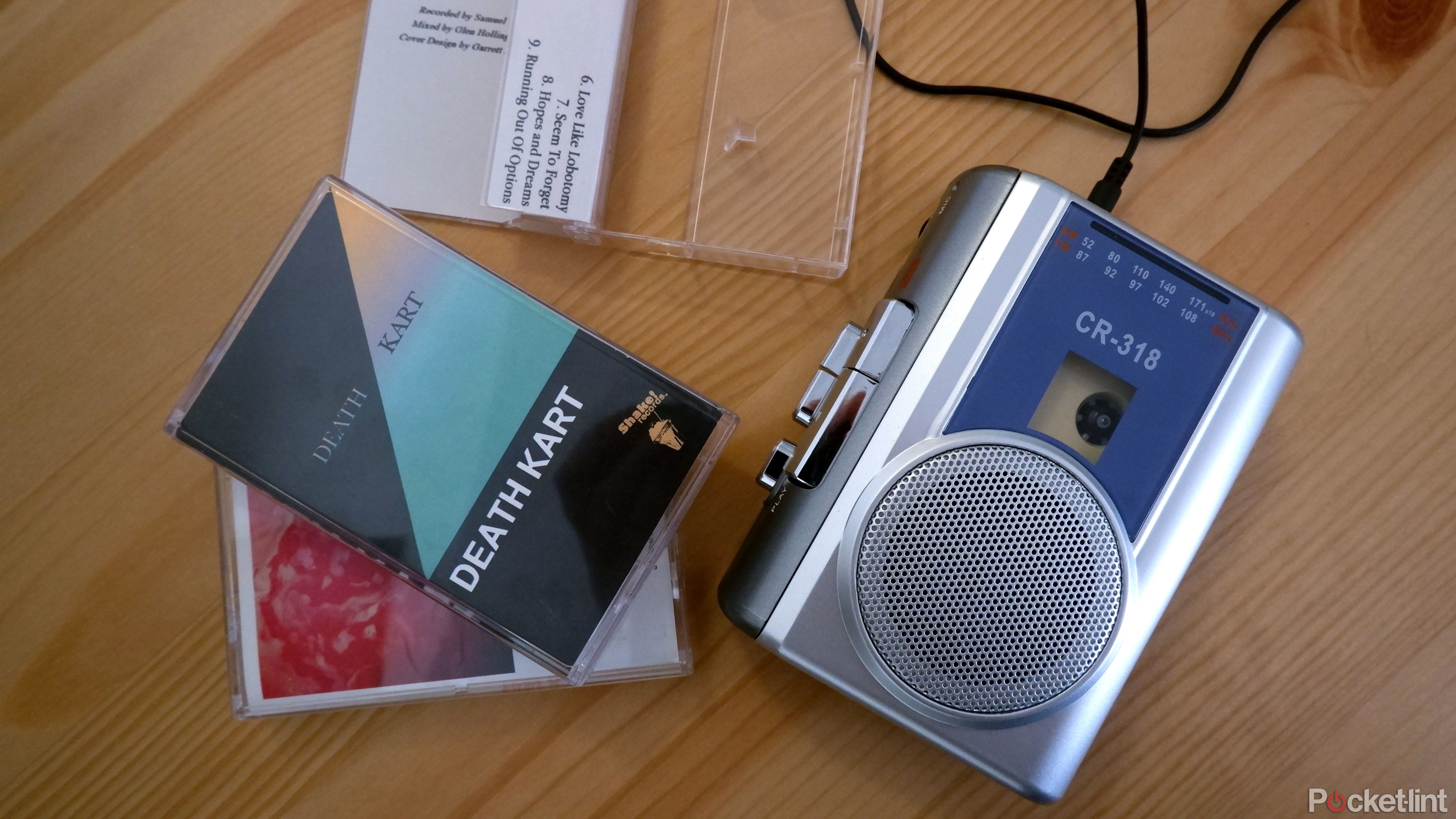 The Gracioso cassette player with tapes beside it on a wooden surface