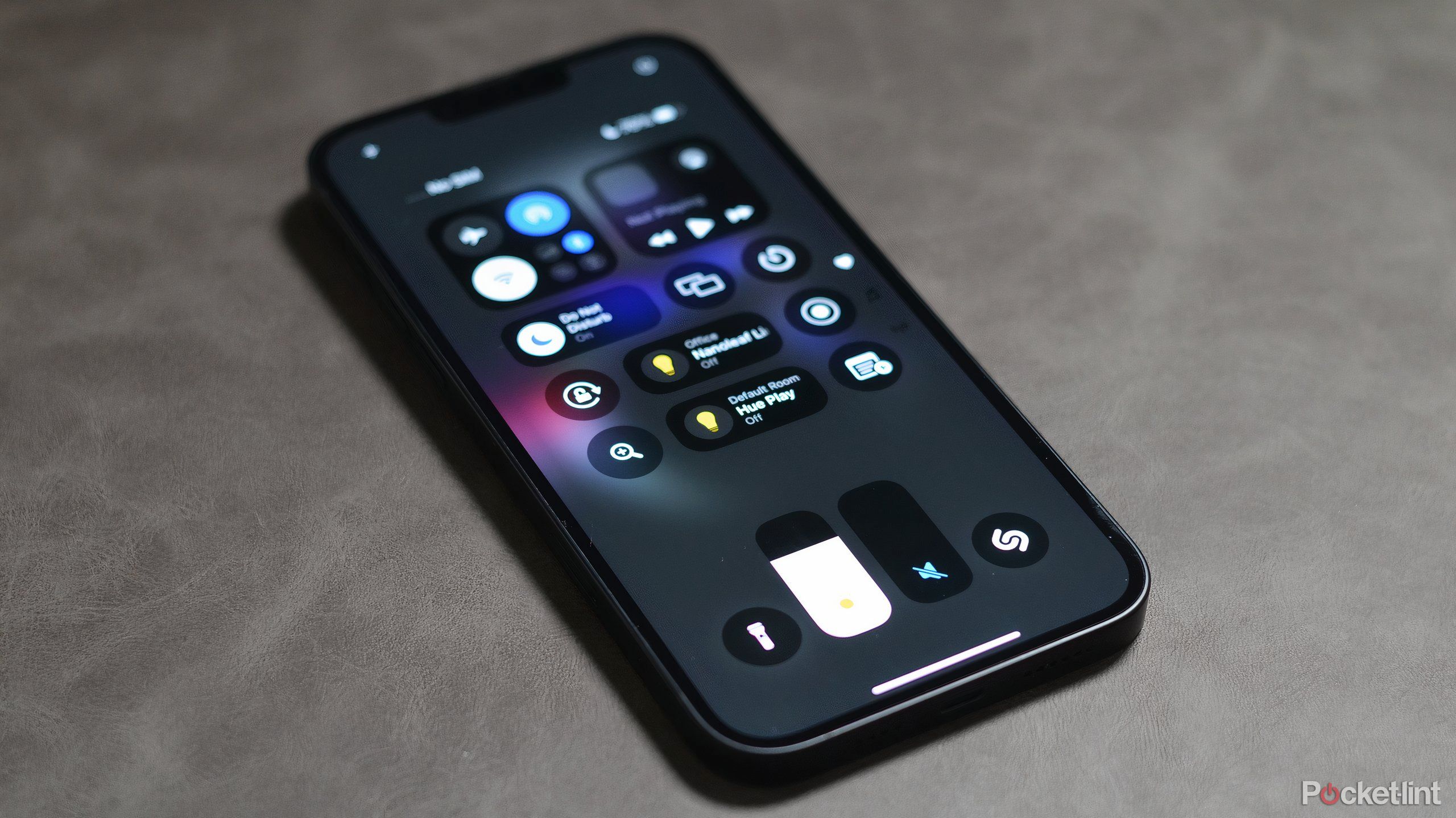 An iPhone with the iOS 18 Control Center open.