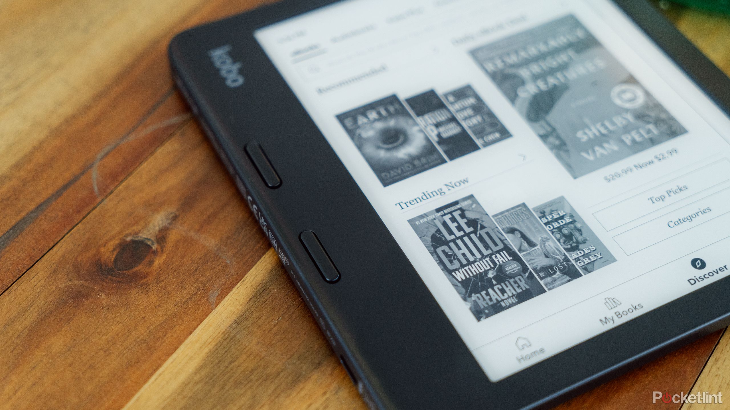 The Kobo Libra 2 sits on a wood coffee table. 