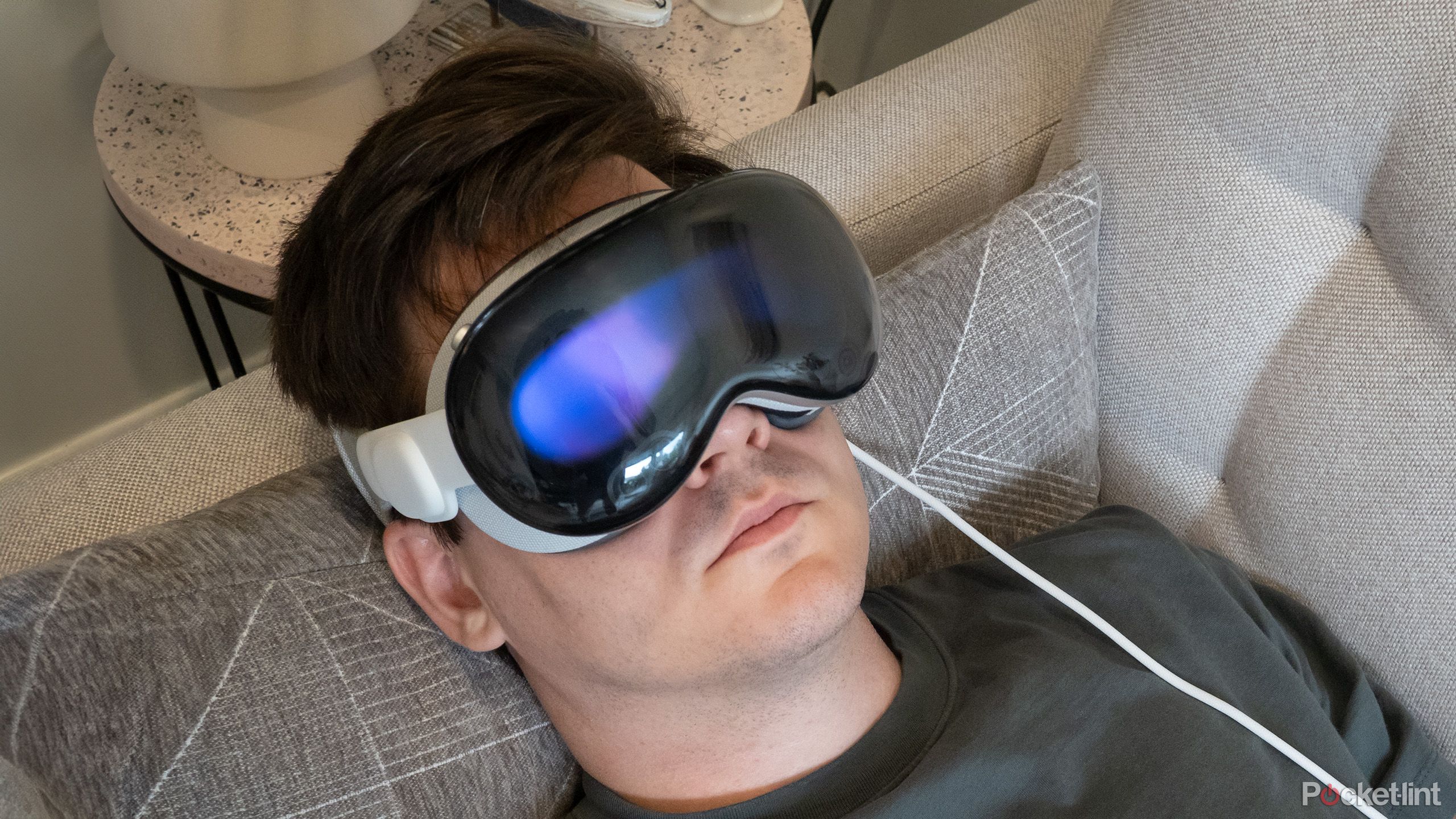 Patrick is relaxing on the couch wearing Vision Pro.