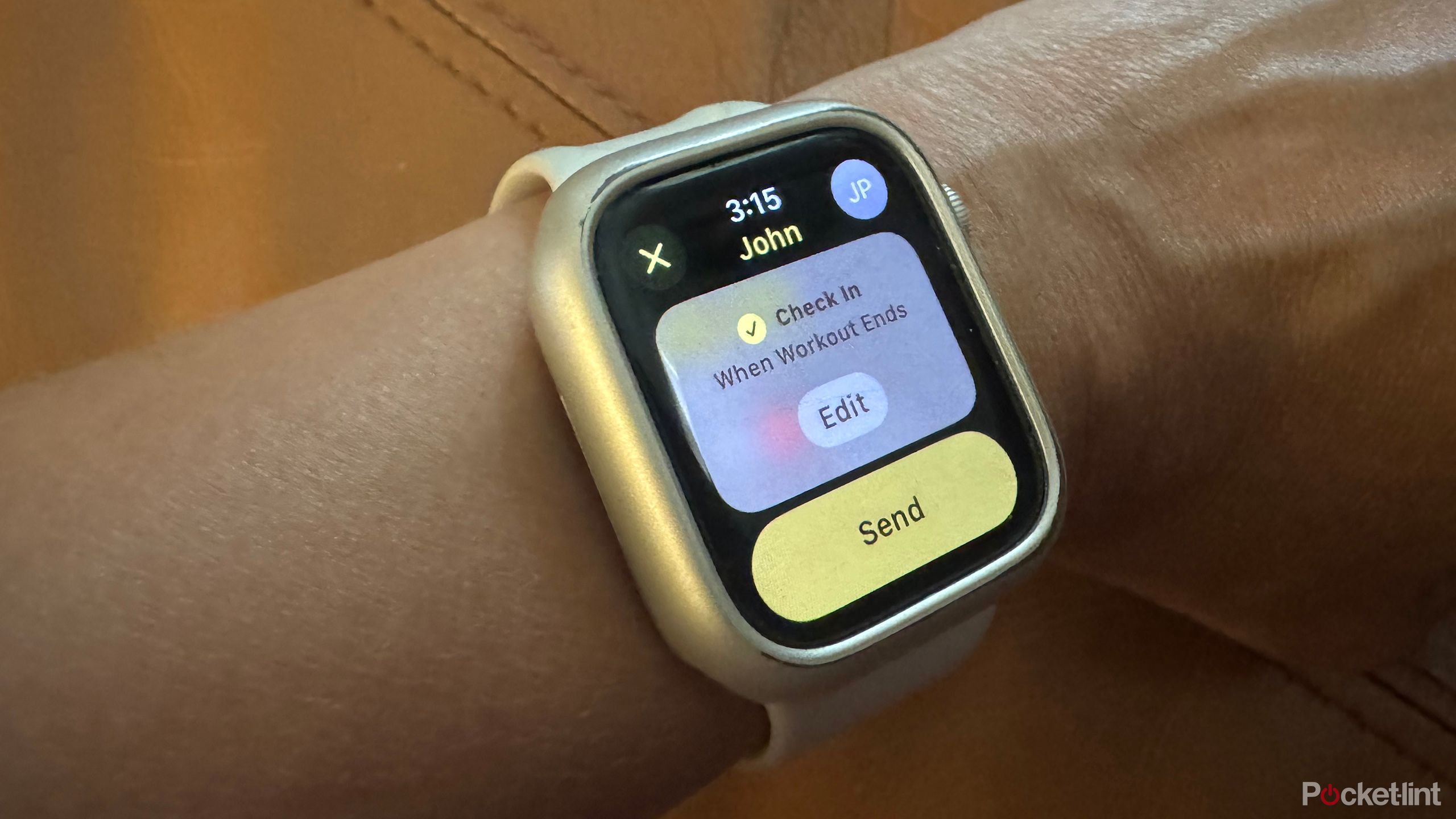 An Apple Watch on a wrist showing Check In during a workout.