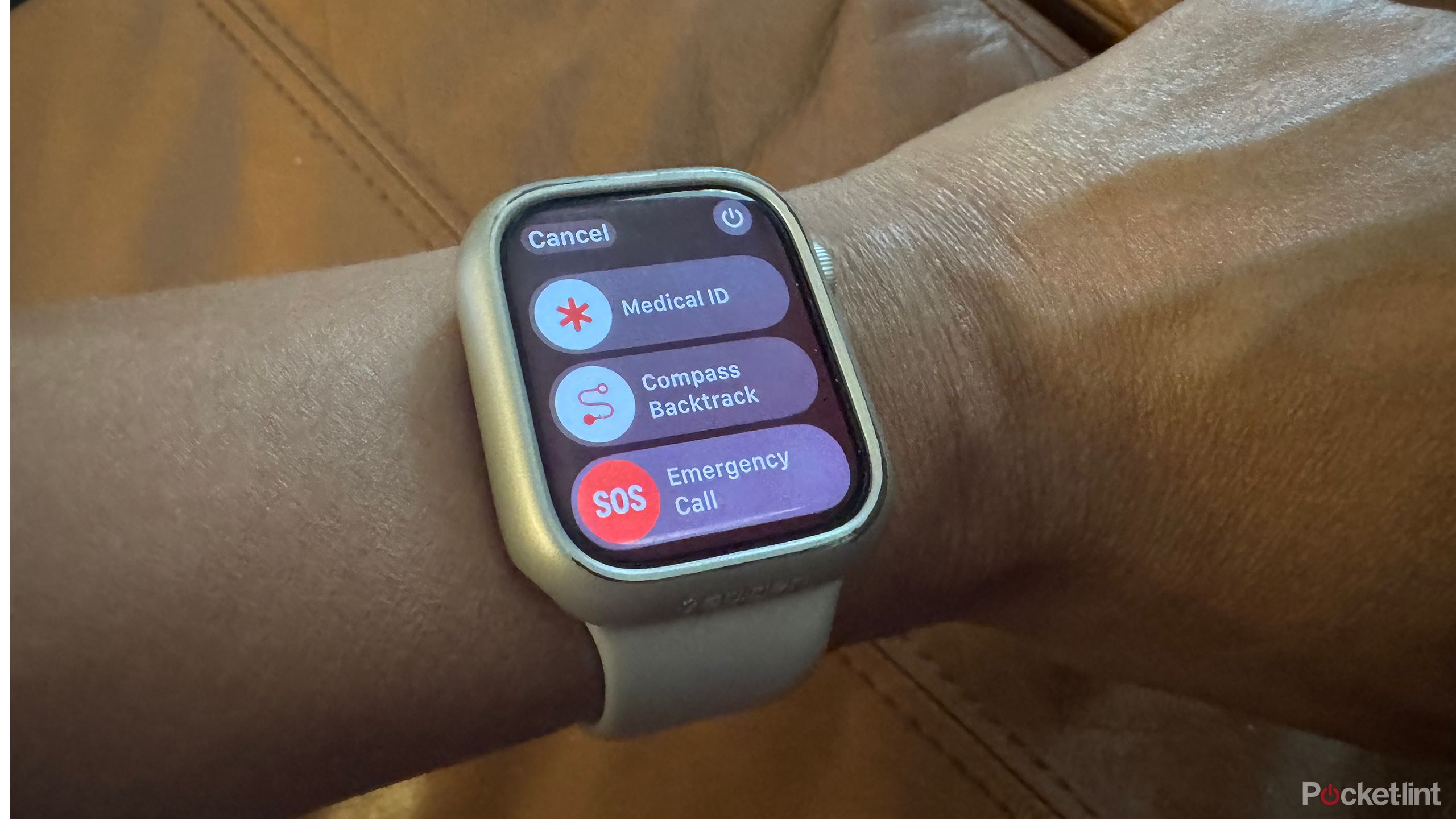 Apple Watch on wrist showing Medical ID, Compass Backtrack, and Emergency Call.