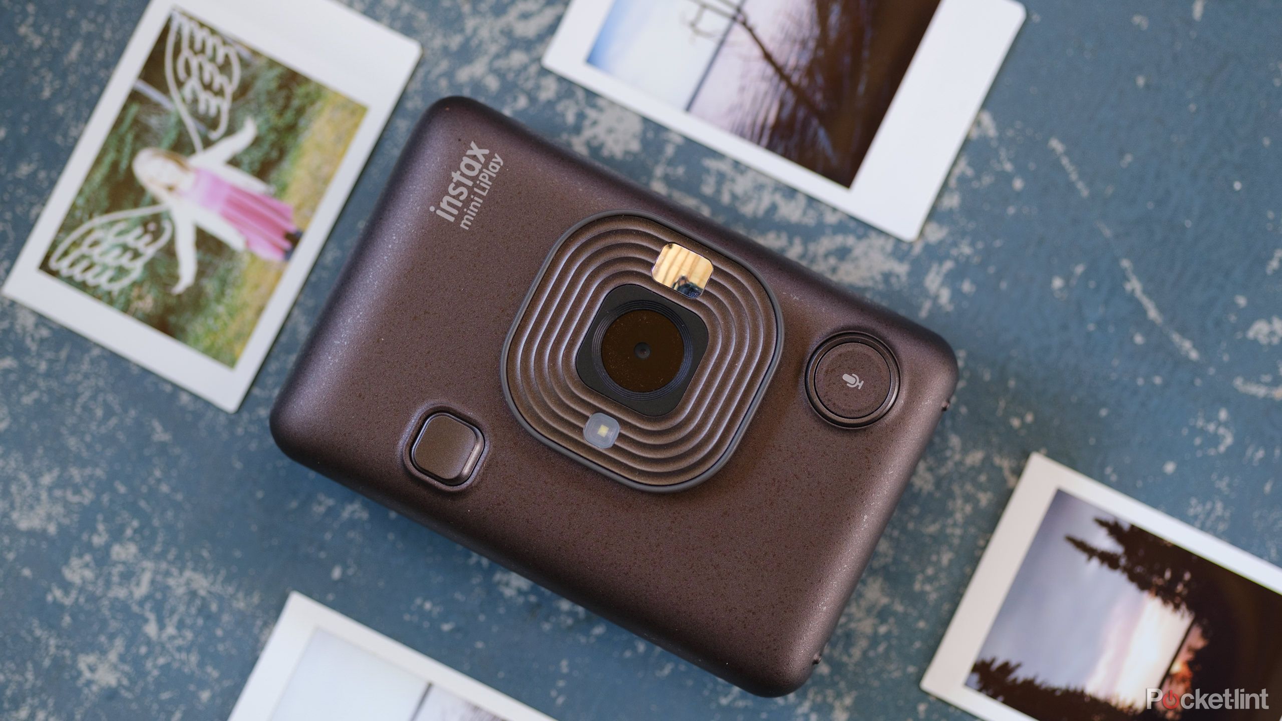 Fujifilm Instax Mini LiPlay with prints around. 