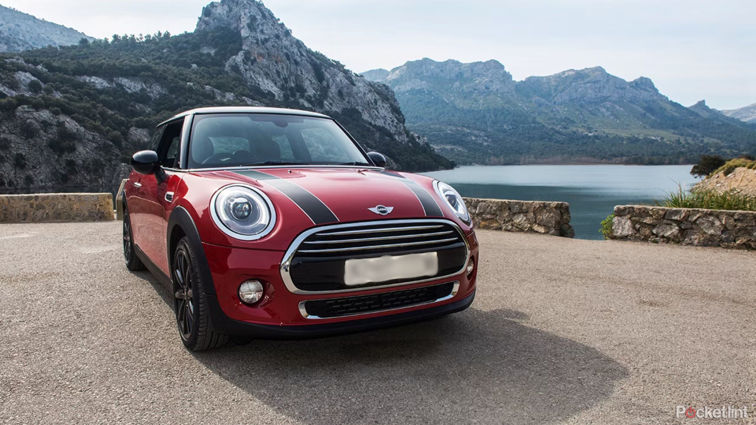 Red mini cooper beside the water