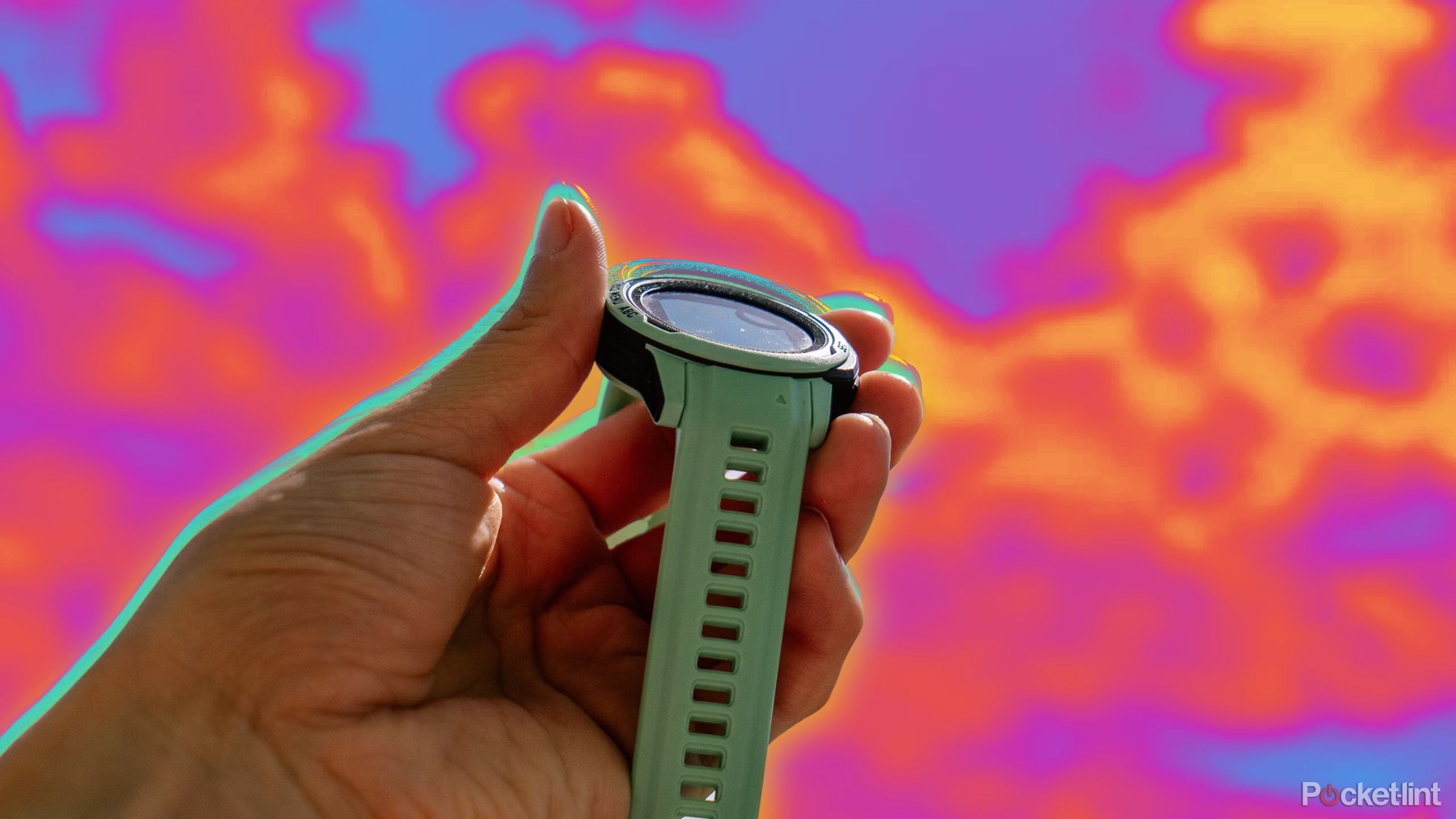 A hand holds the Garmin Instinct 2S Solar in front of blue sky with fluffy white clouds.