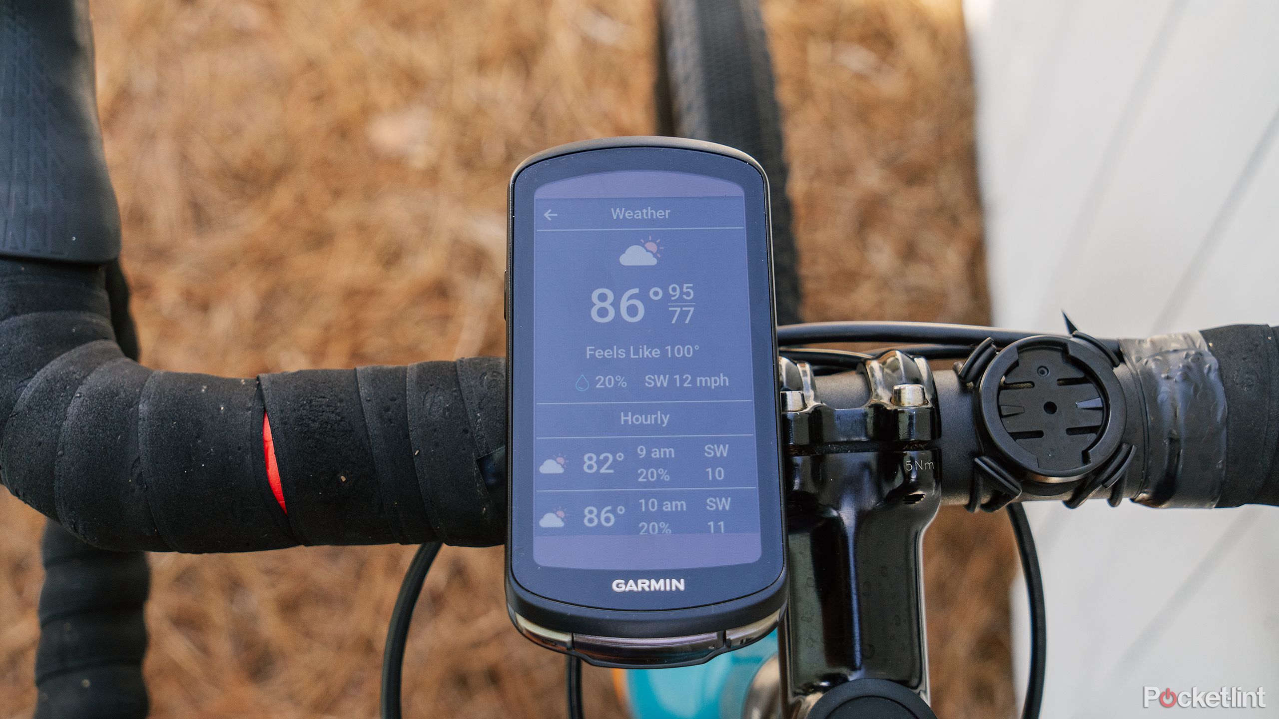 The Garmin Edge 1040 Solar displays the weather while mounted to bike handlebars. 