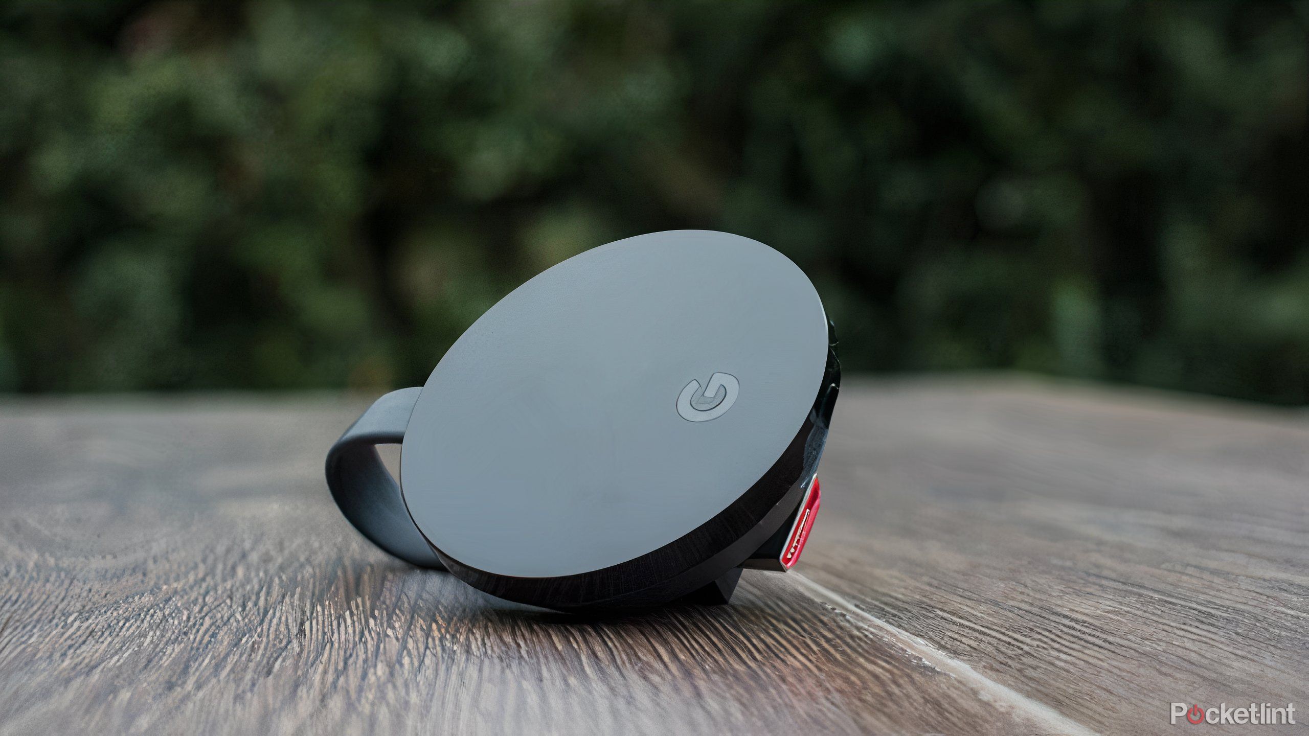 A Chromecast Ultra sitting on a wooden table.