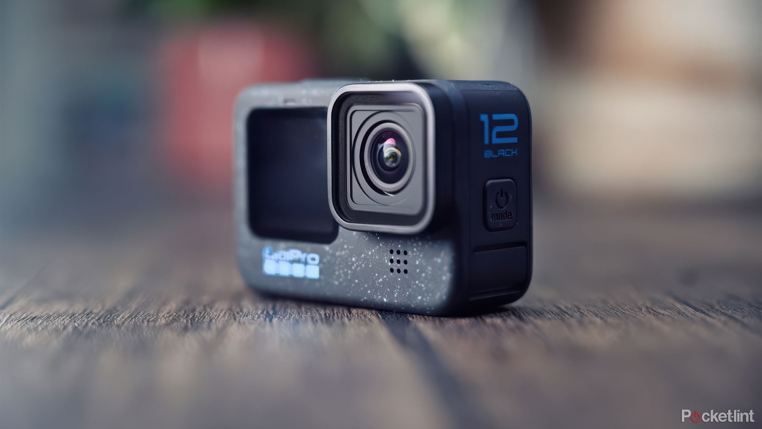 A GoPro Hero 12 Black sits on a wooden table. 