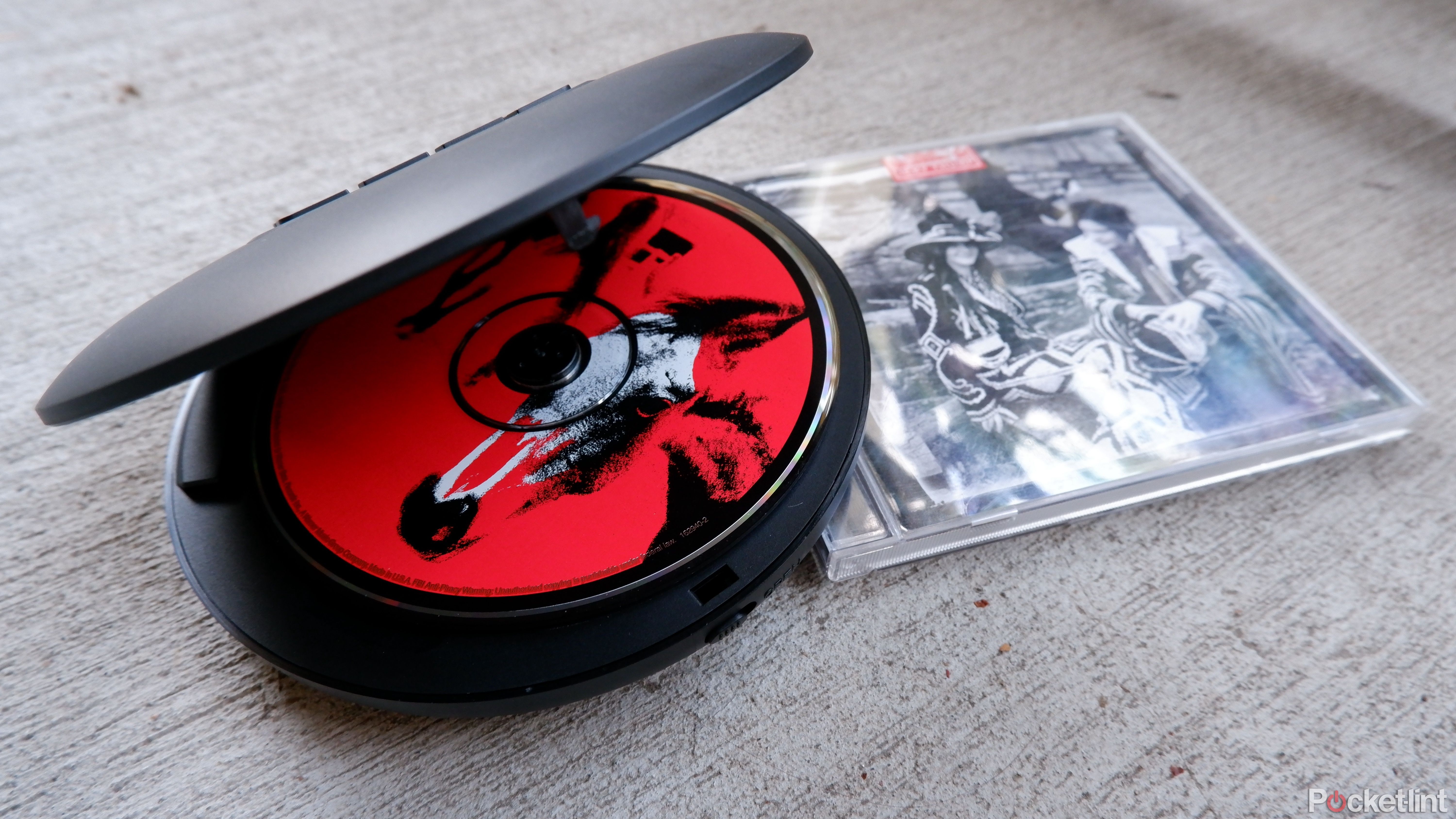 Hott CD204 on a concrete surface with a CD inside, on top of a CD case