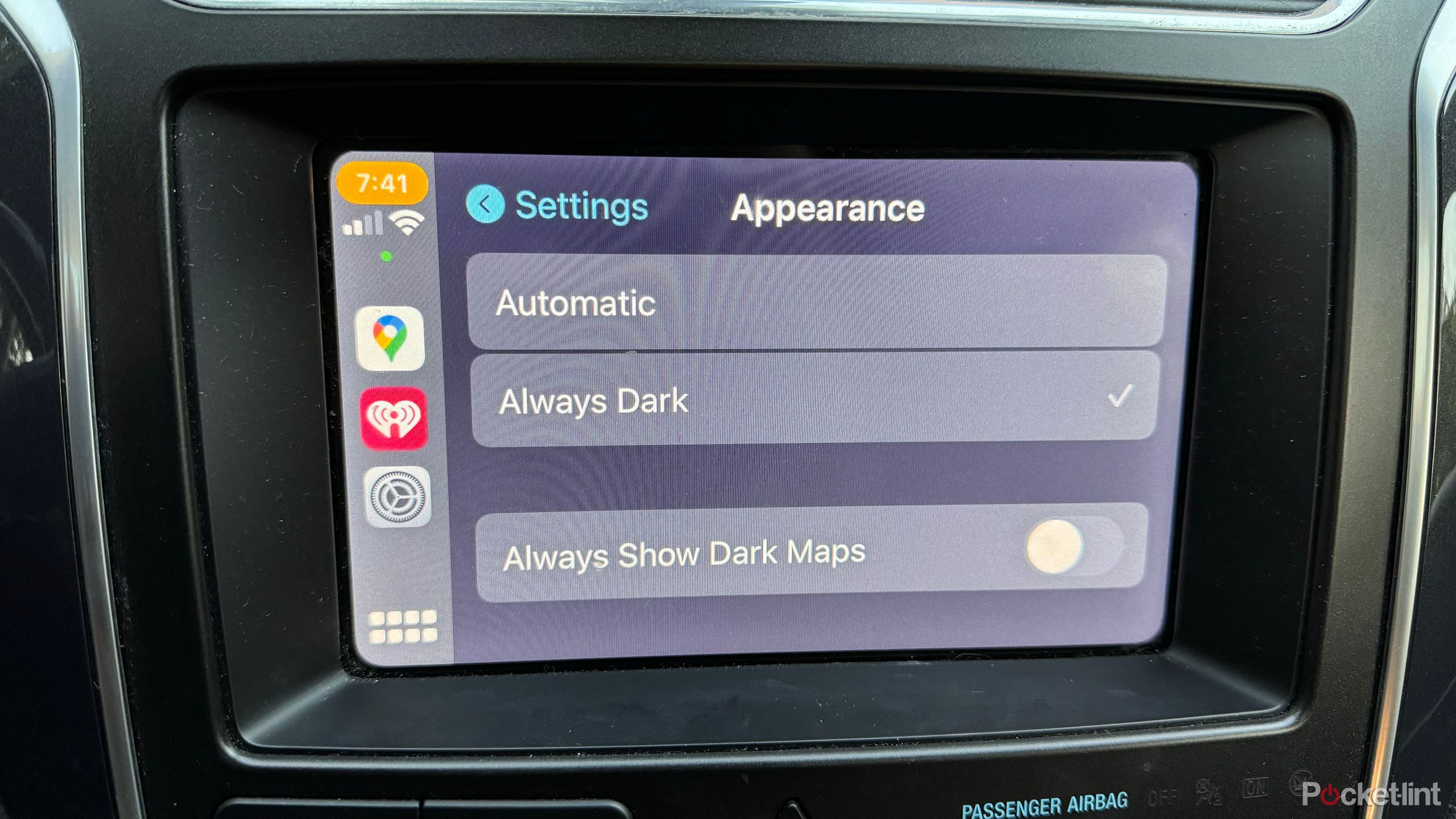 A car's infotainment screen displays Apple CarPlay