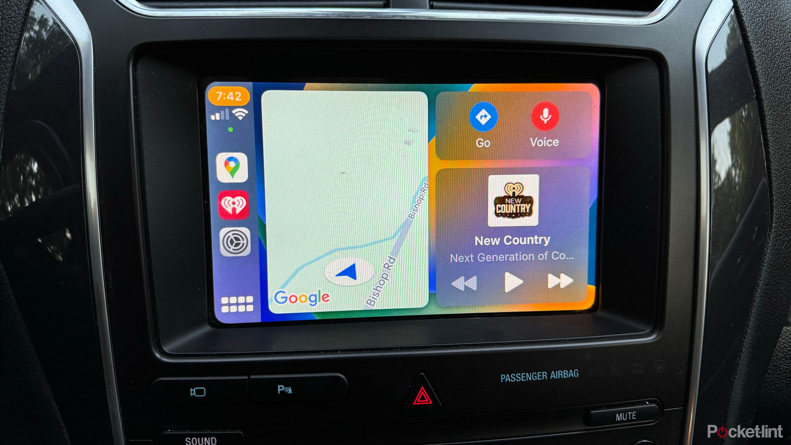 A car's infotainment screen displays Apple CarPlay