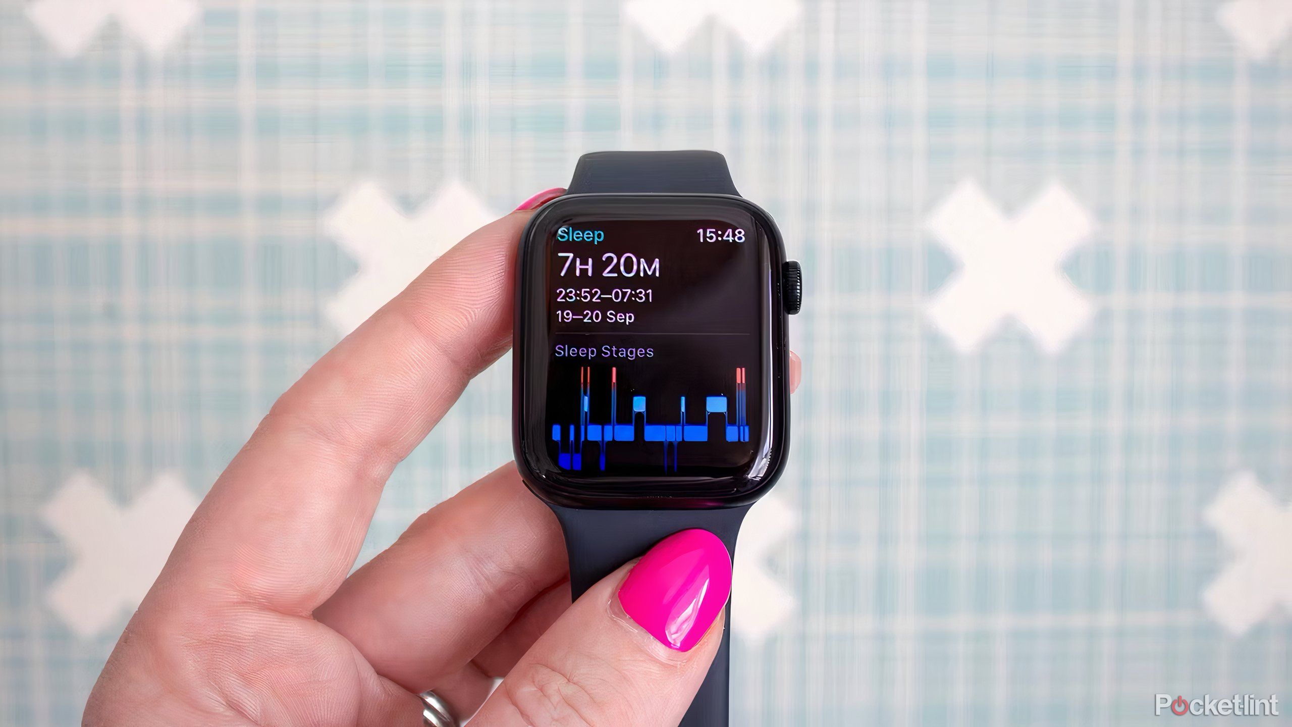 A hand holding an Apple Watch SE showing sleep tracking information.