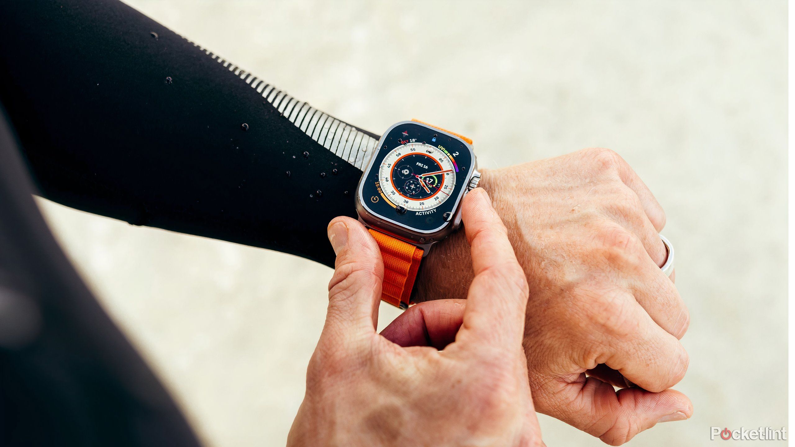 Pressing the Action Button on the side of the Apple Watch Ultra 2.