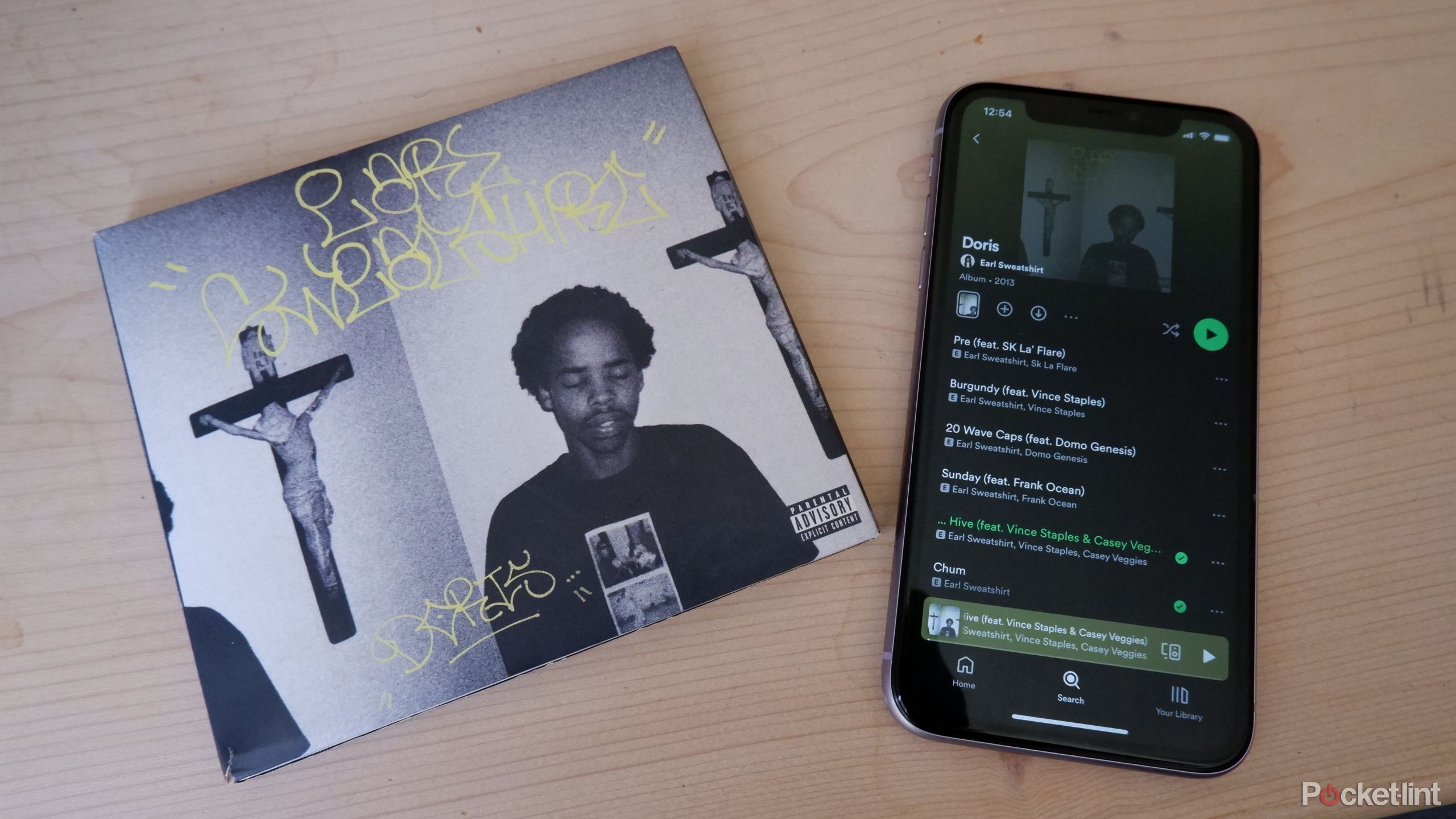 Earl Sweatshirt's album Doris in CD format and on Spotify on an iPhone