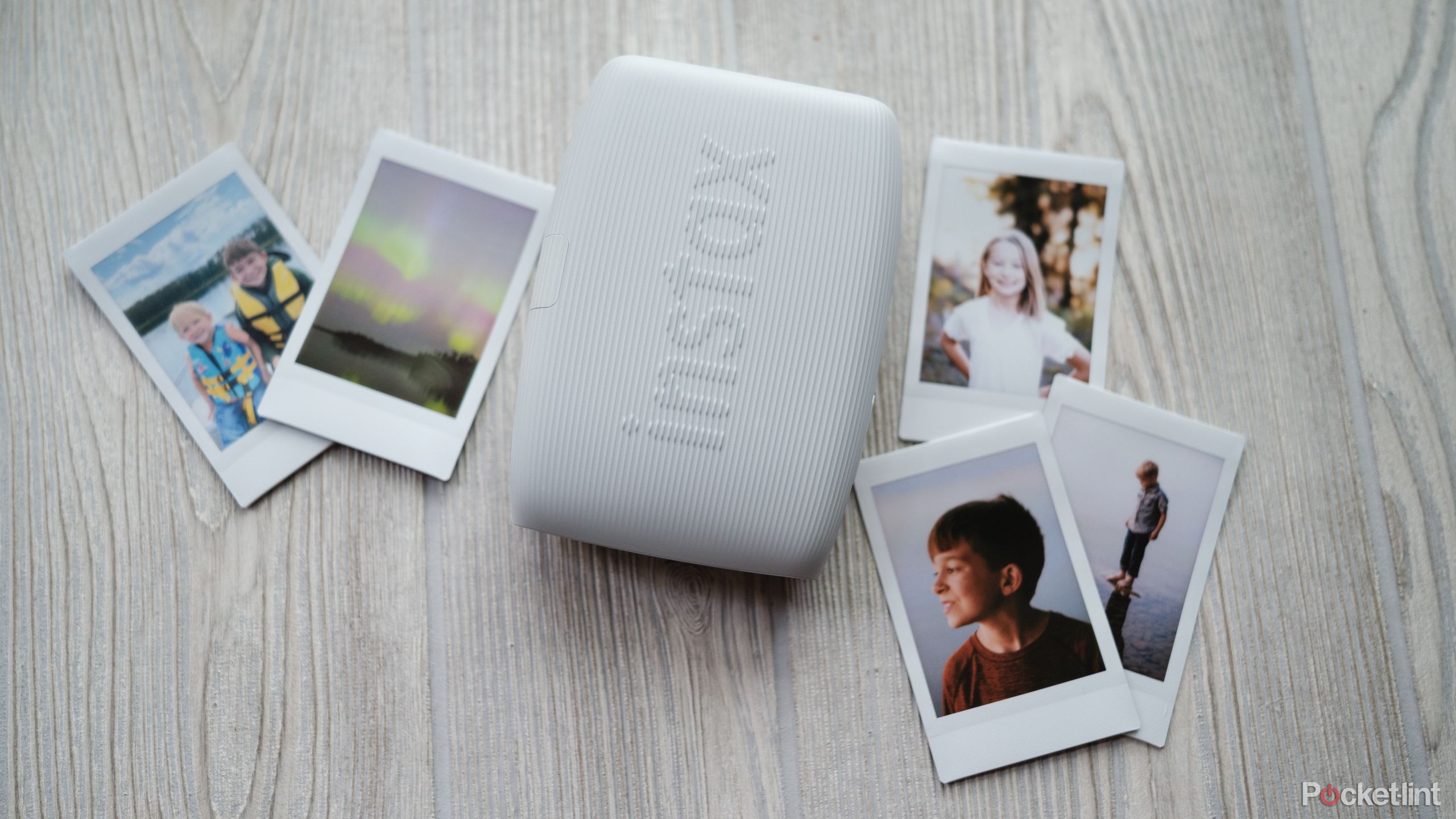 A photograph of the Fujifilm Instax Mini Link 3 with prints