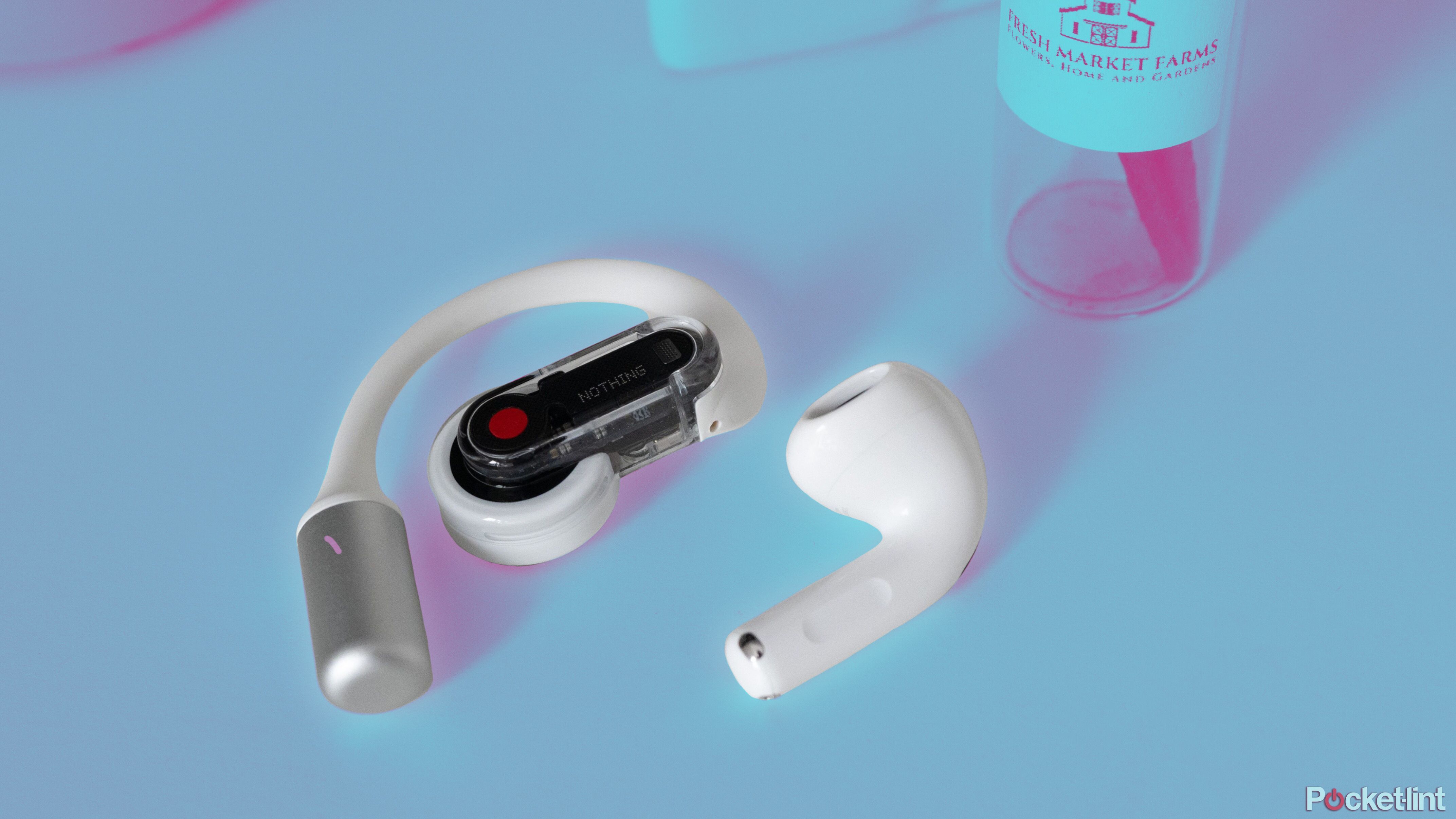 The Nothing Ear (Open) and an AirPod next to each other on a table.