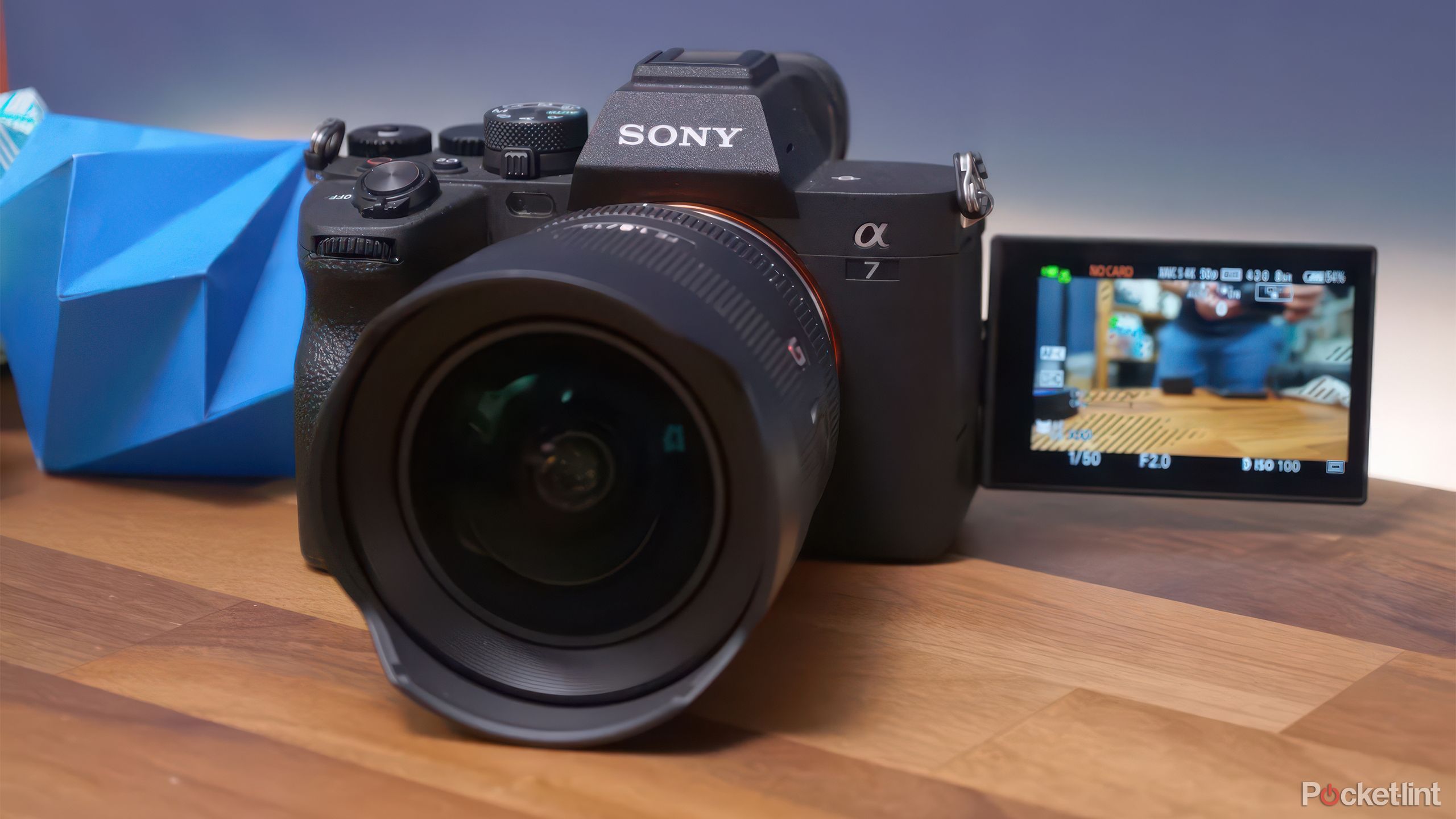 The Sony A7 IV sits on a table with the screen flipped out. 