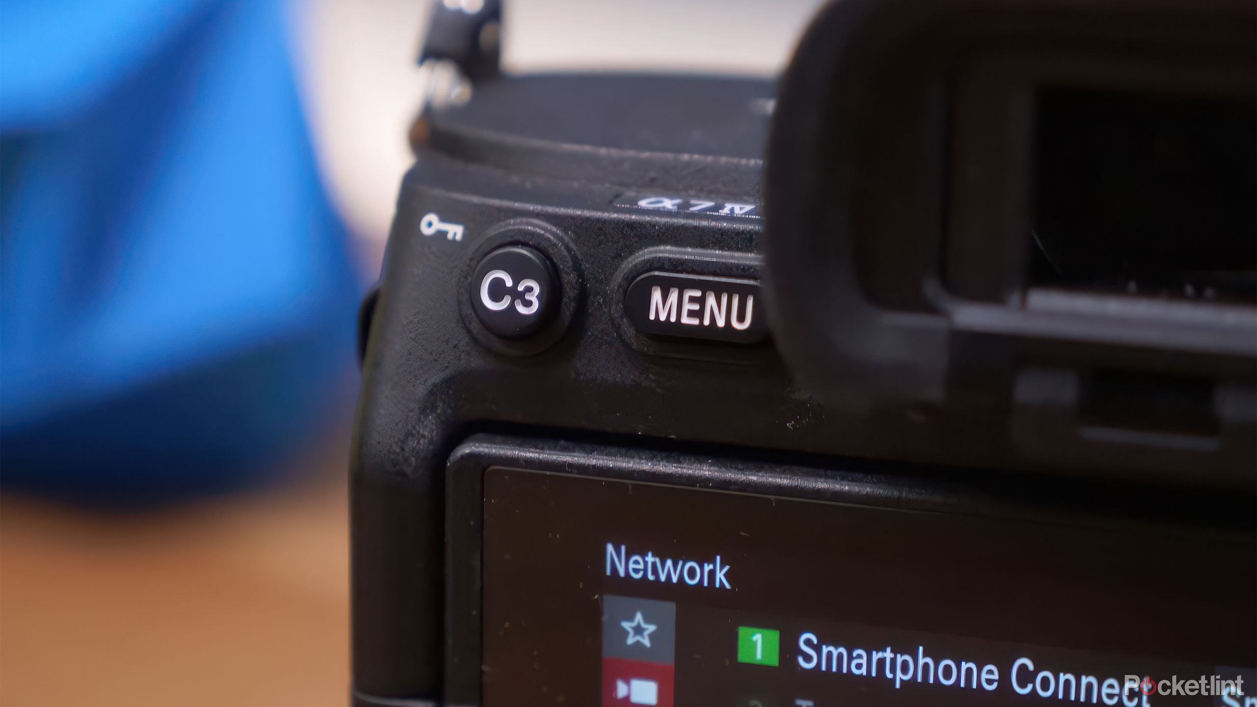 The Sony A7 IV sits on a table with the display on. 