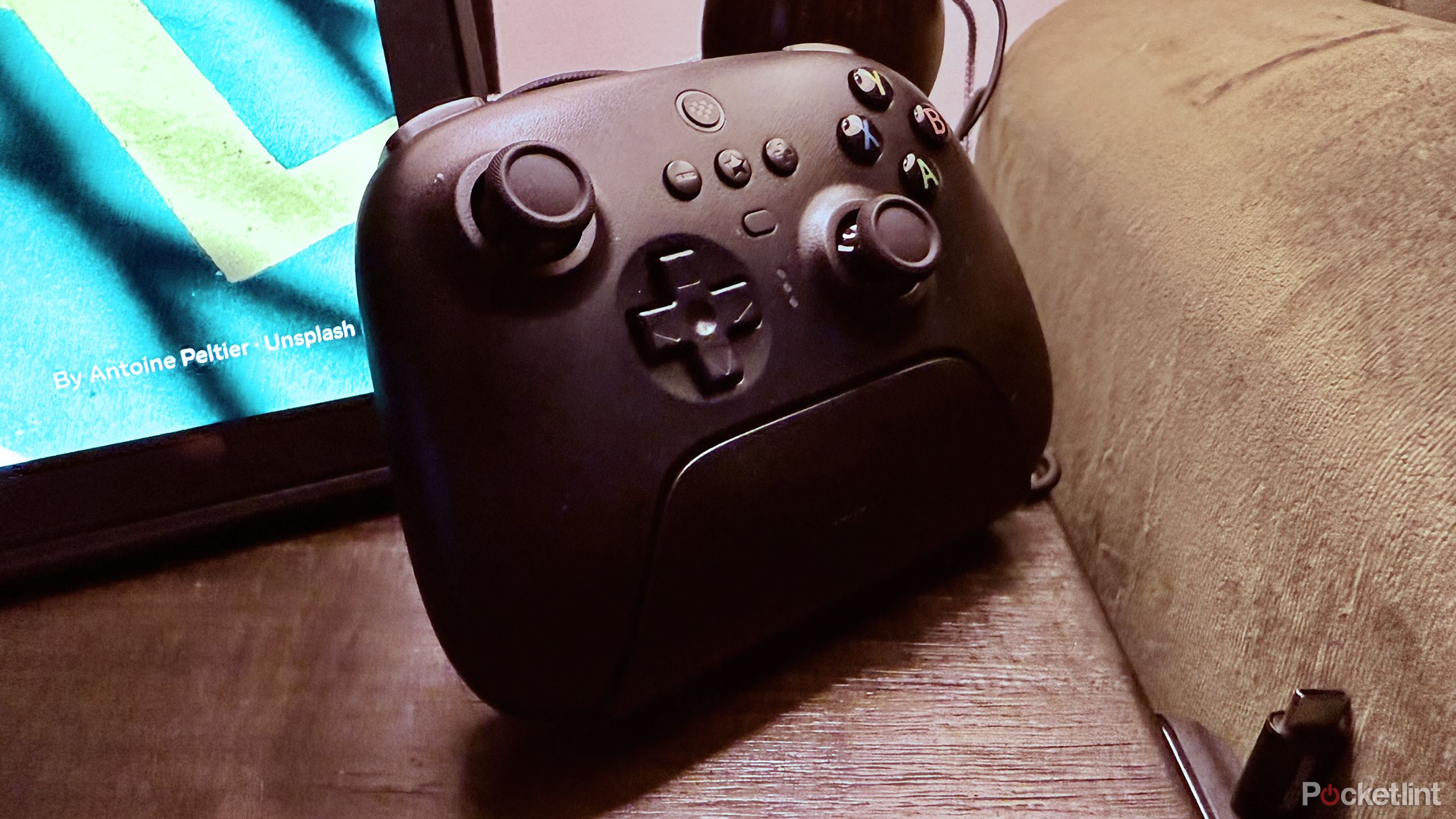 An 8BitDo Ultimate Controller in its dock.