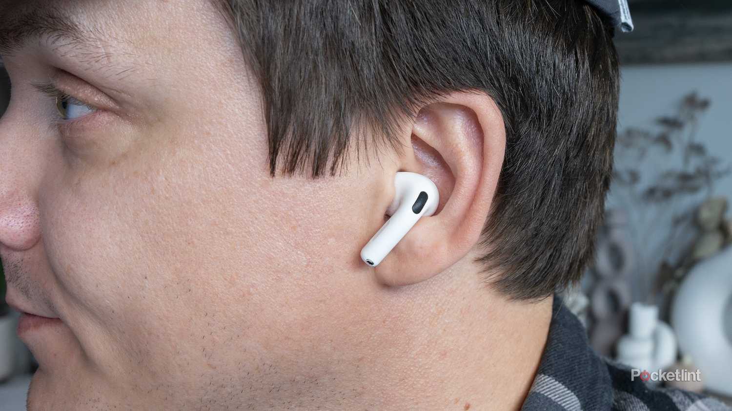 The AirPods 4 sitting in an ear