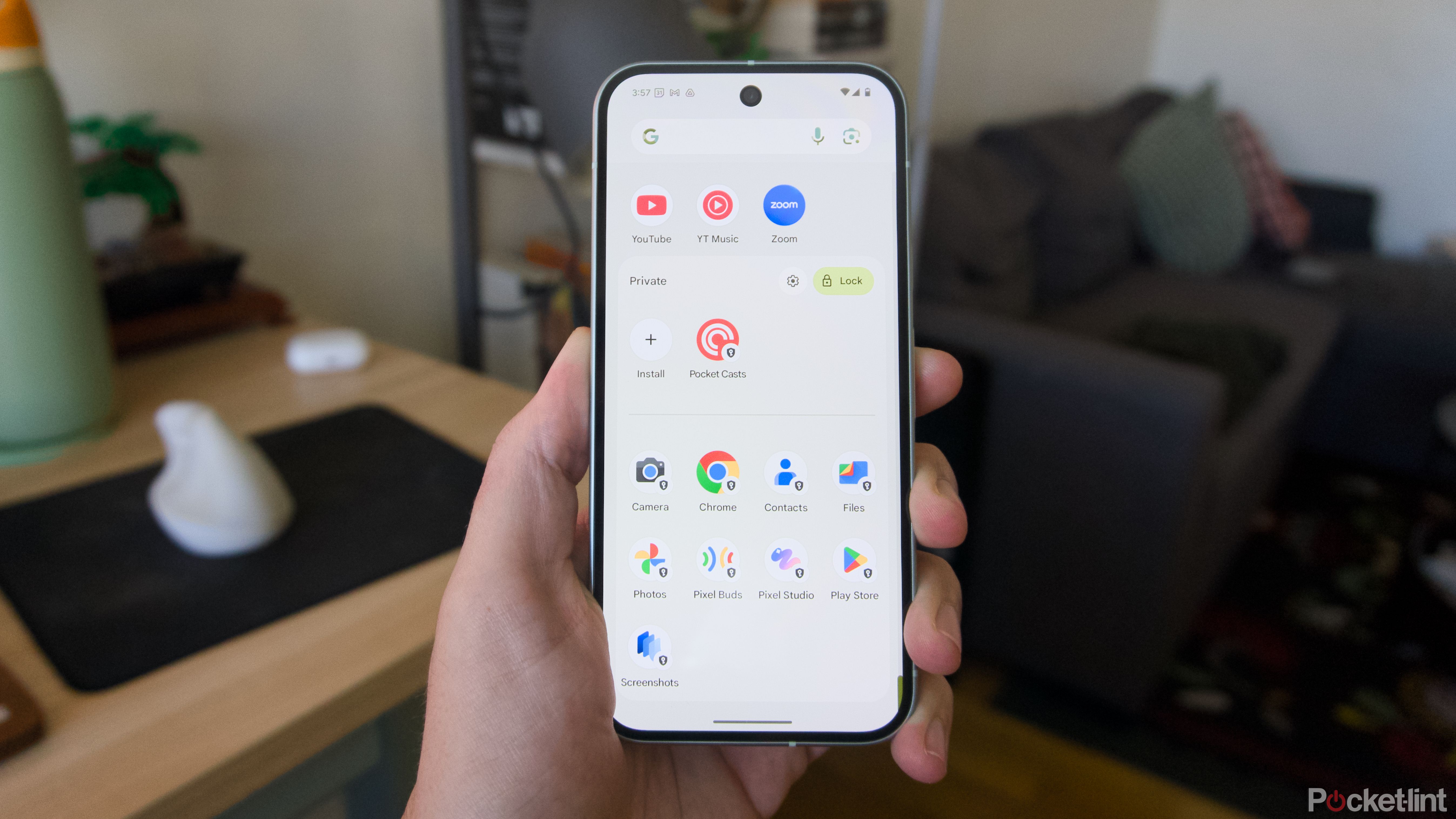 A hand holding a Pixel 9 showing off an unlocked Private Space.