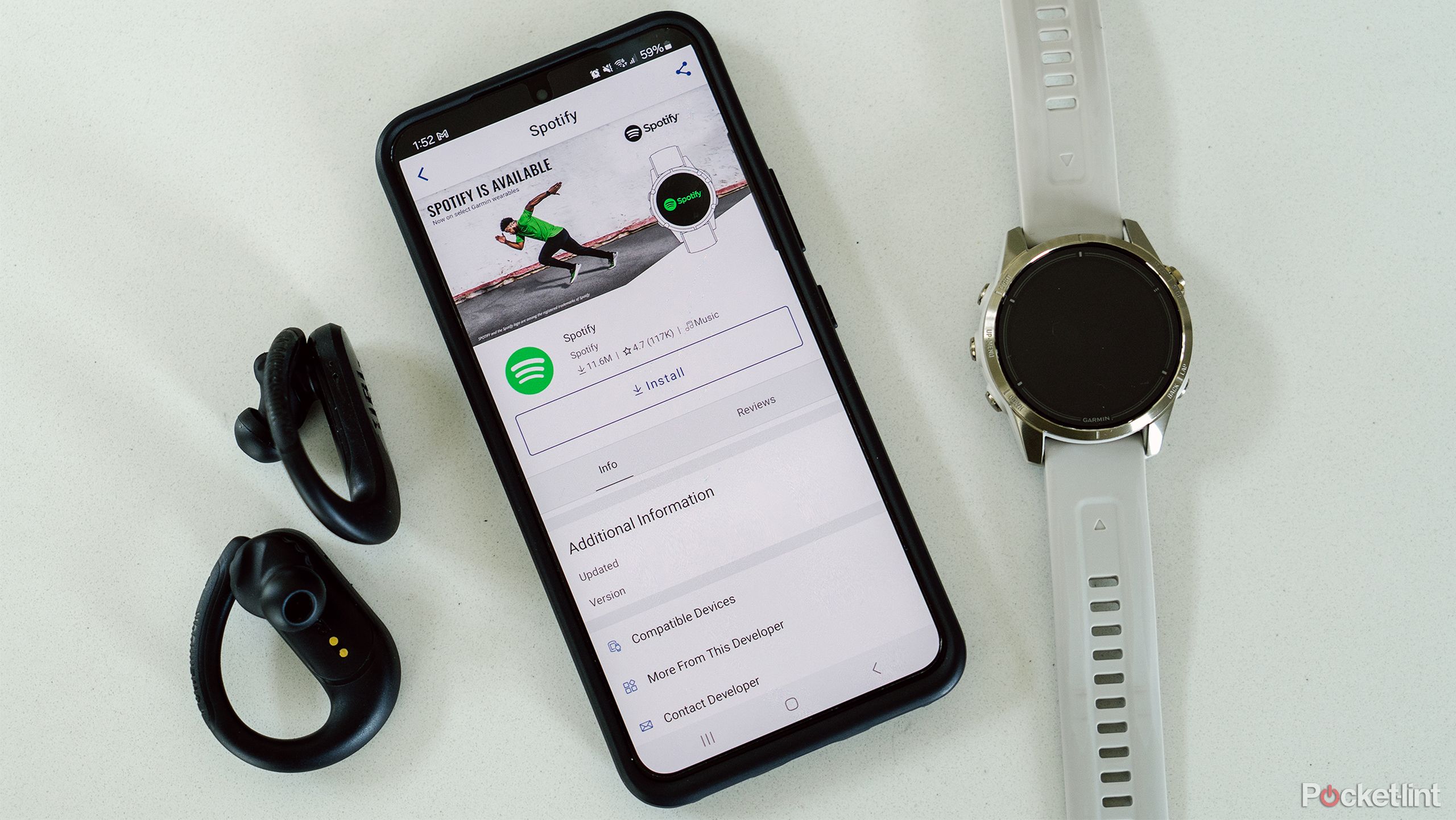 The Garmin epix Pro Gen 2 sits next to a Samsung Galaxy with Garmin Connect's Spotify app on the screen.