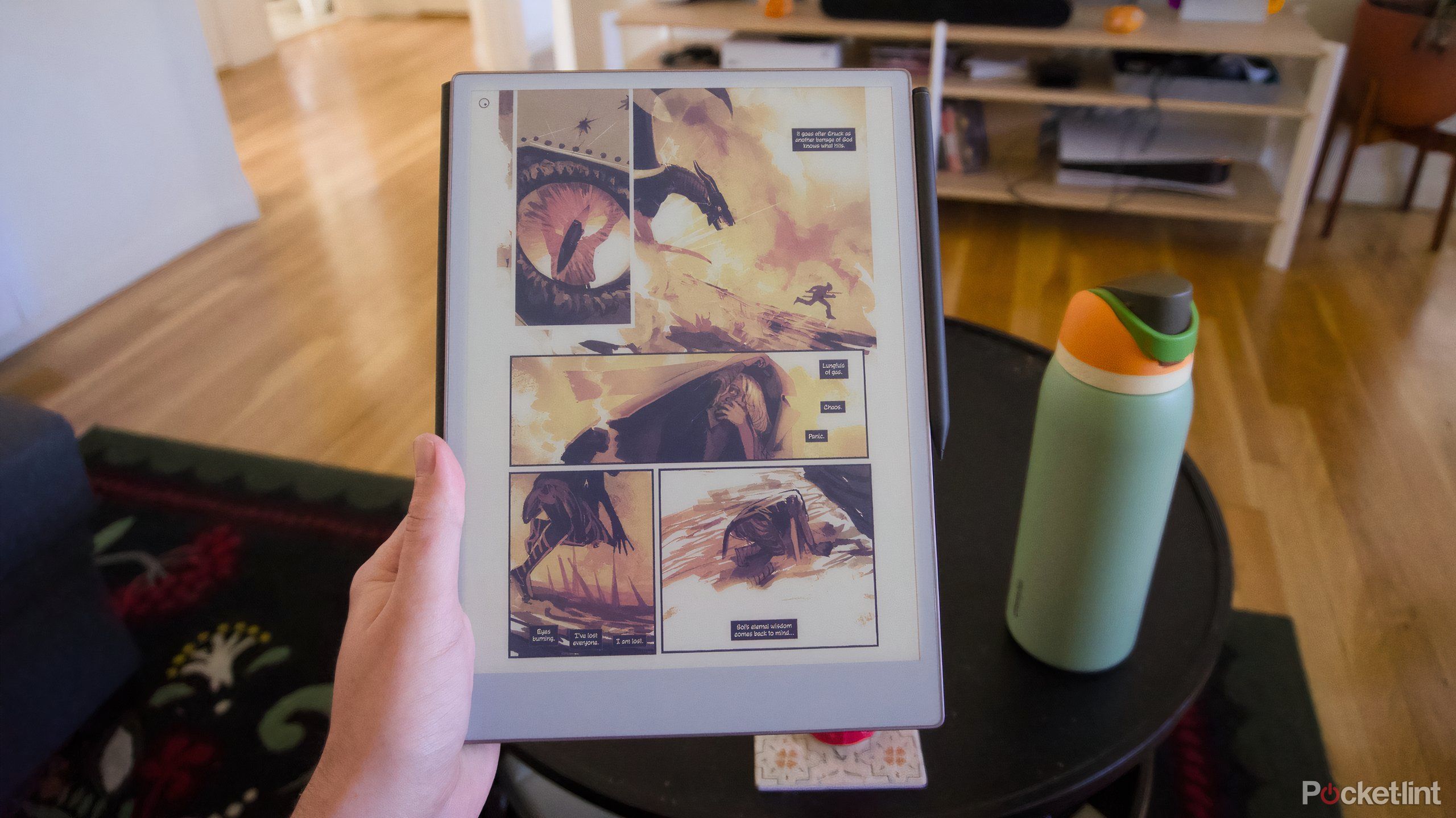 a hand holding the reMarkable Paper Pro displaying a comic.