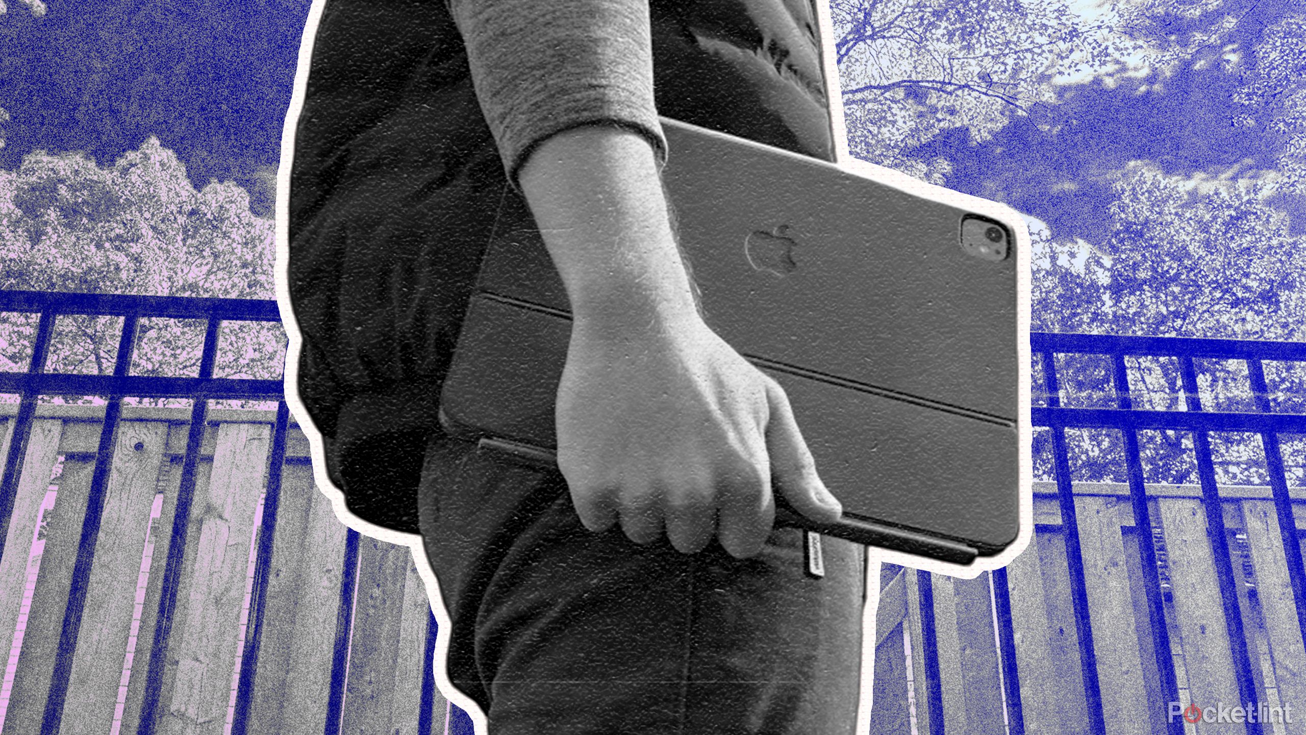 A man holding an iPad Pro in a case outside. 