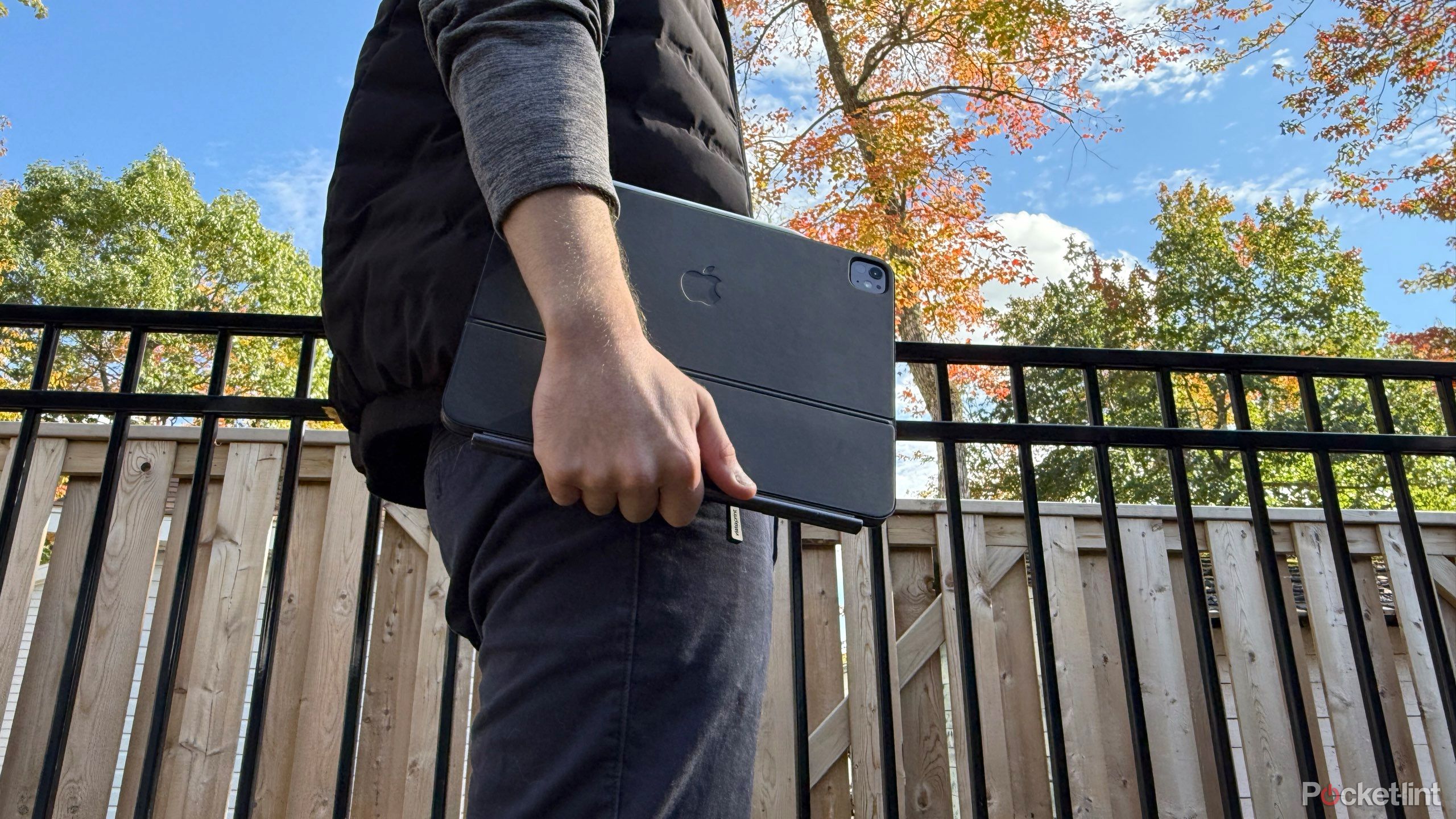 A man standing with an iPad Pro in hand.