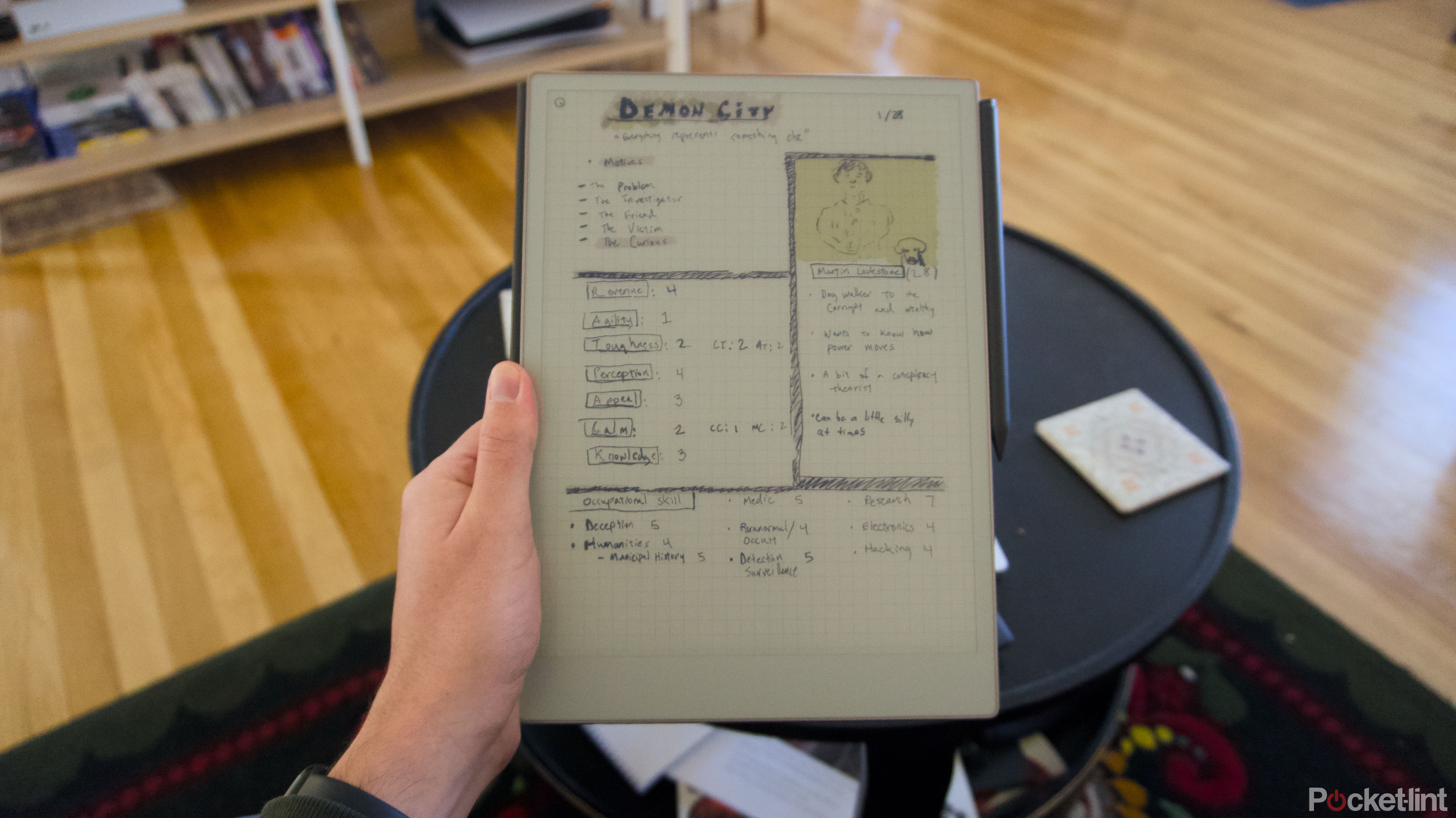 A hand holding a reMarkable Paper Pro showing a tabletop roleplaying game character sheet.