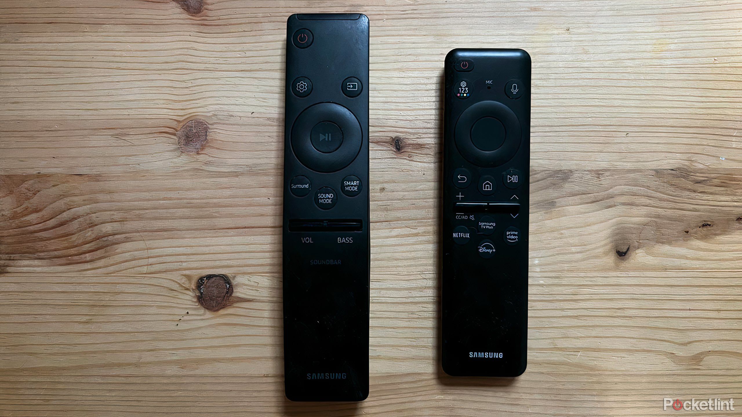 Samsung OLED Smart TV remote next to Samsung soundbar remote