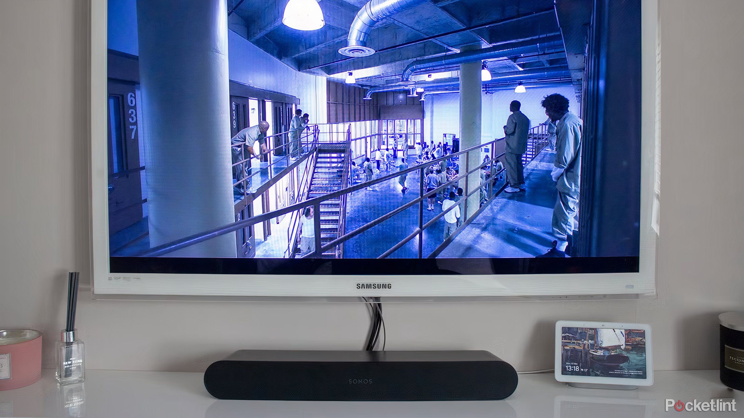 A black Sonos Ray sound bar under a white television.