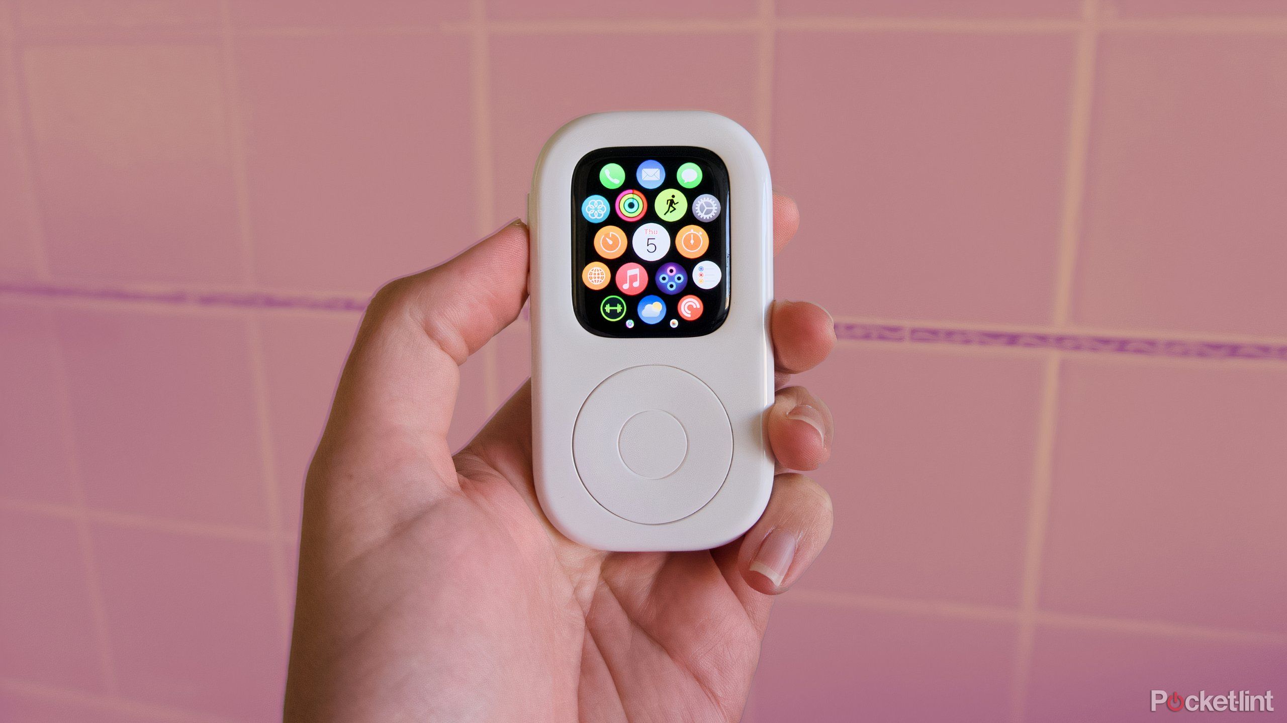 A hand holding an Apple Watch inside a white case shaped like an iPod.