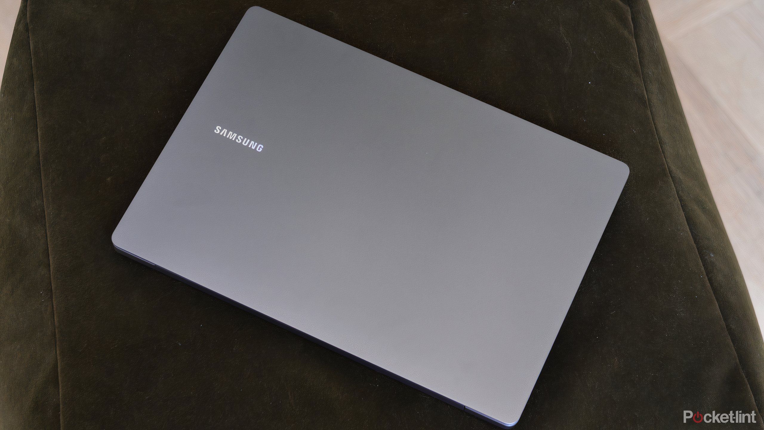 A Samsung Galaxy Book5 closed on a cushion.