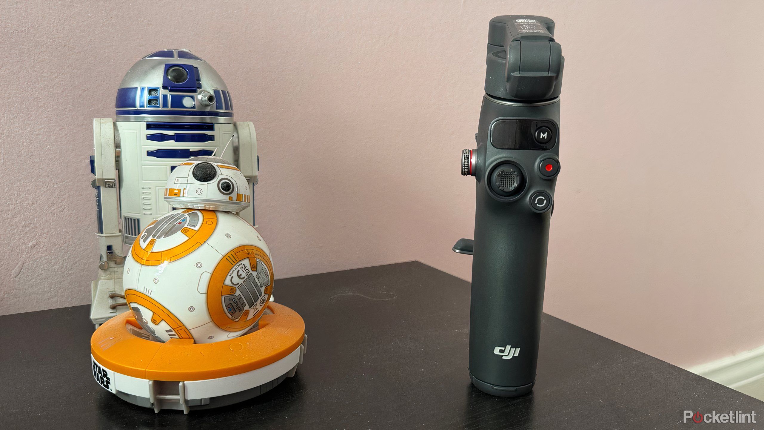 The DJI Osmo 7P gimbal beside two droids. 