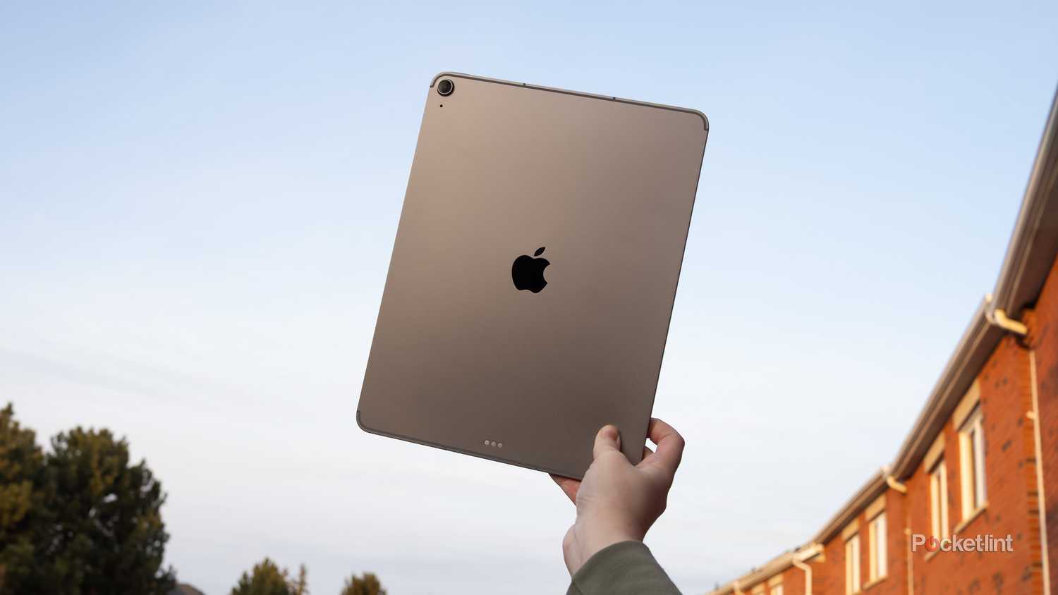 An M3 iPad Air held against the sky.