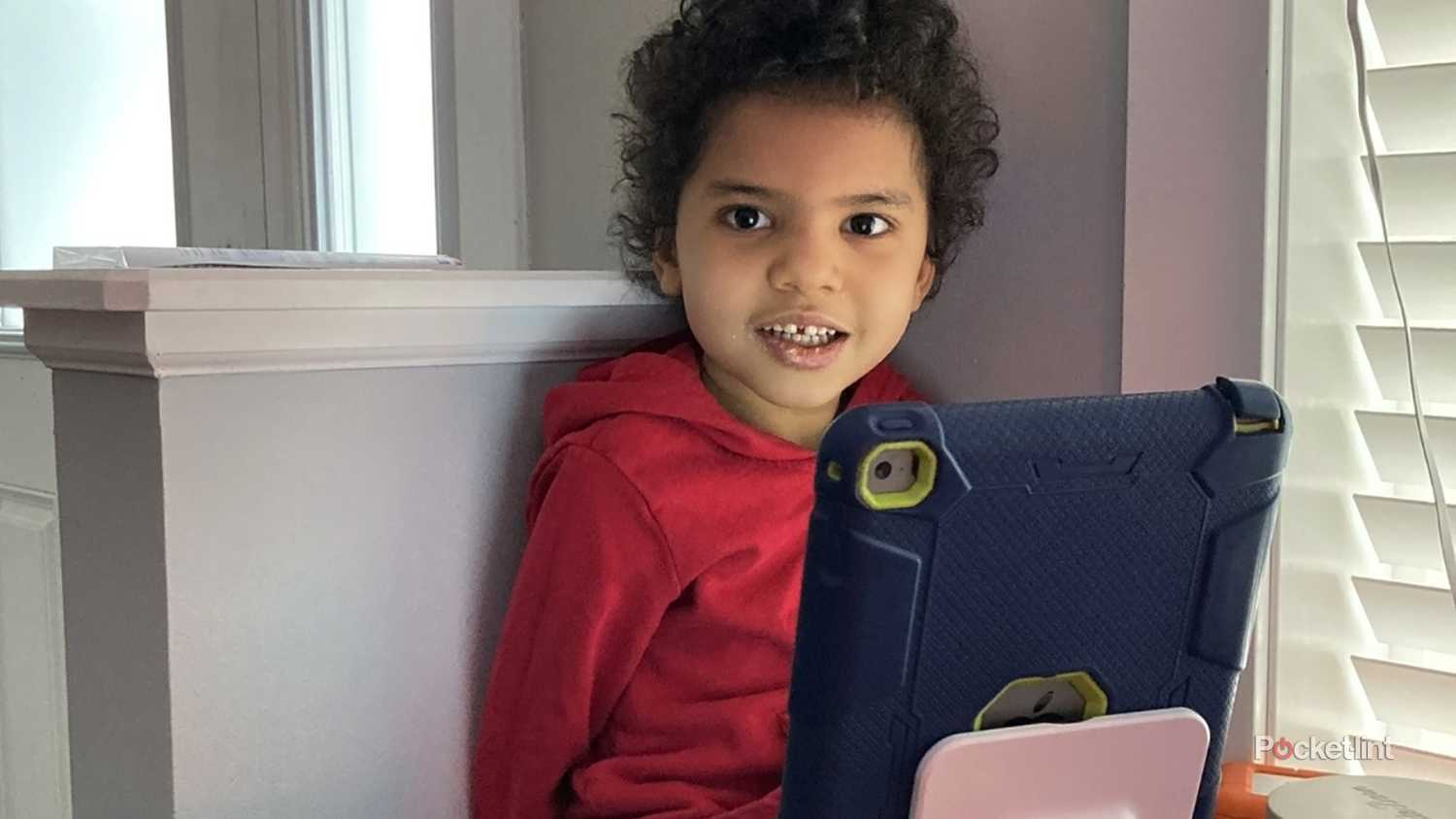 A child using an iPad in a rugged case.