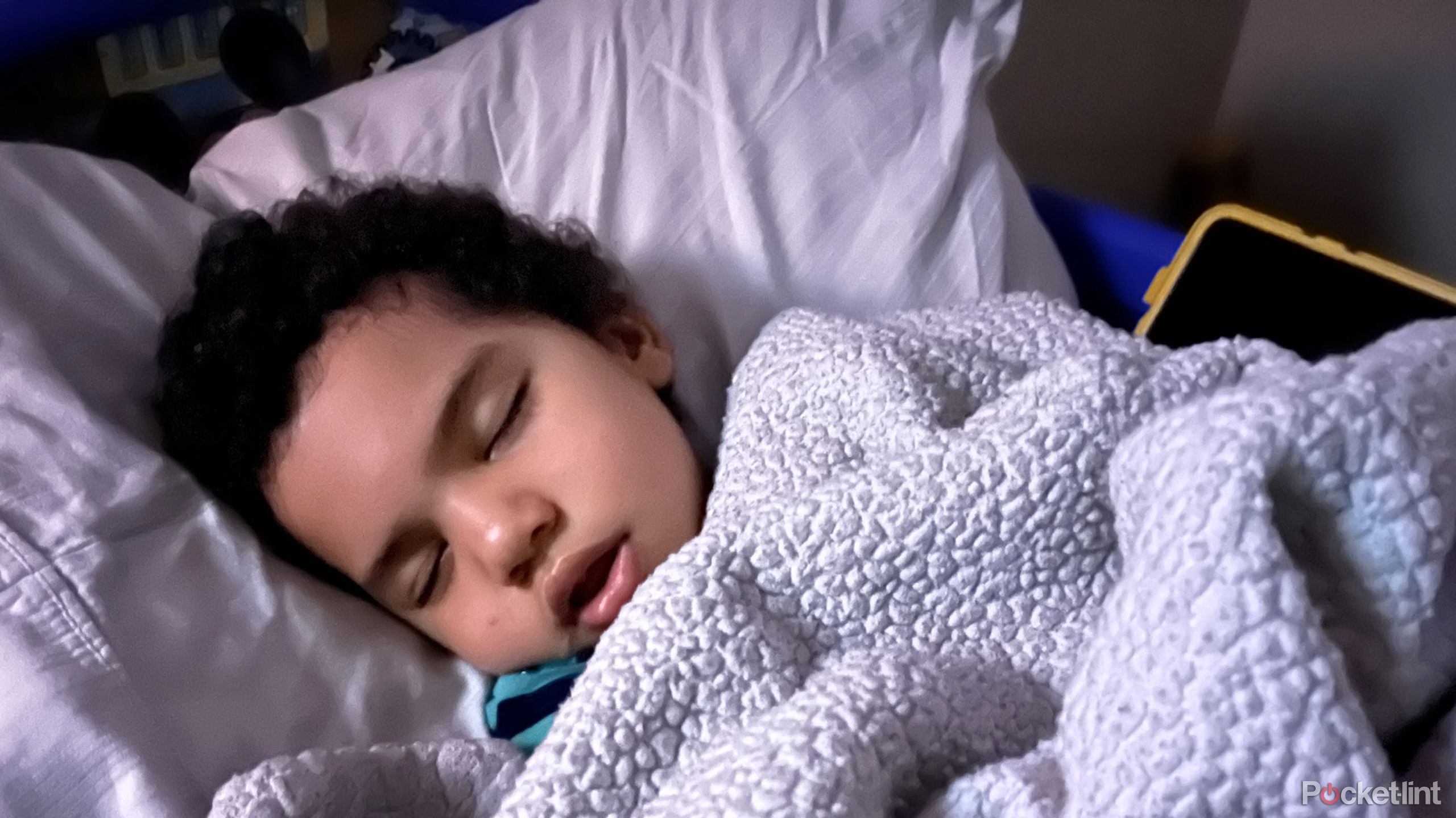A child sleeping next to an iPad.