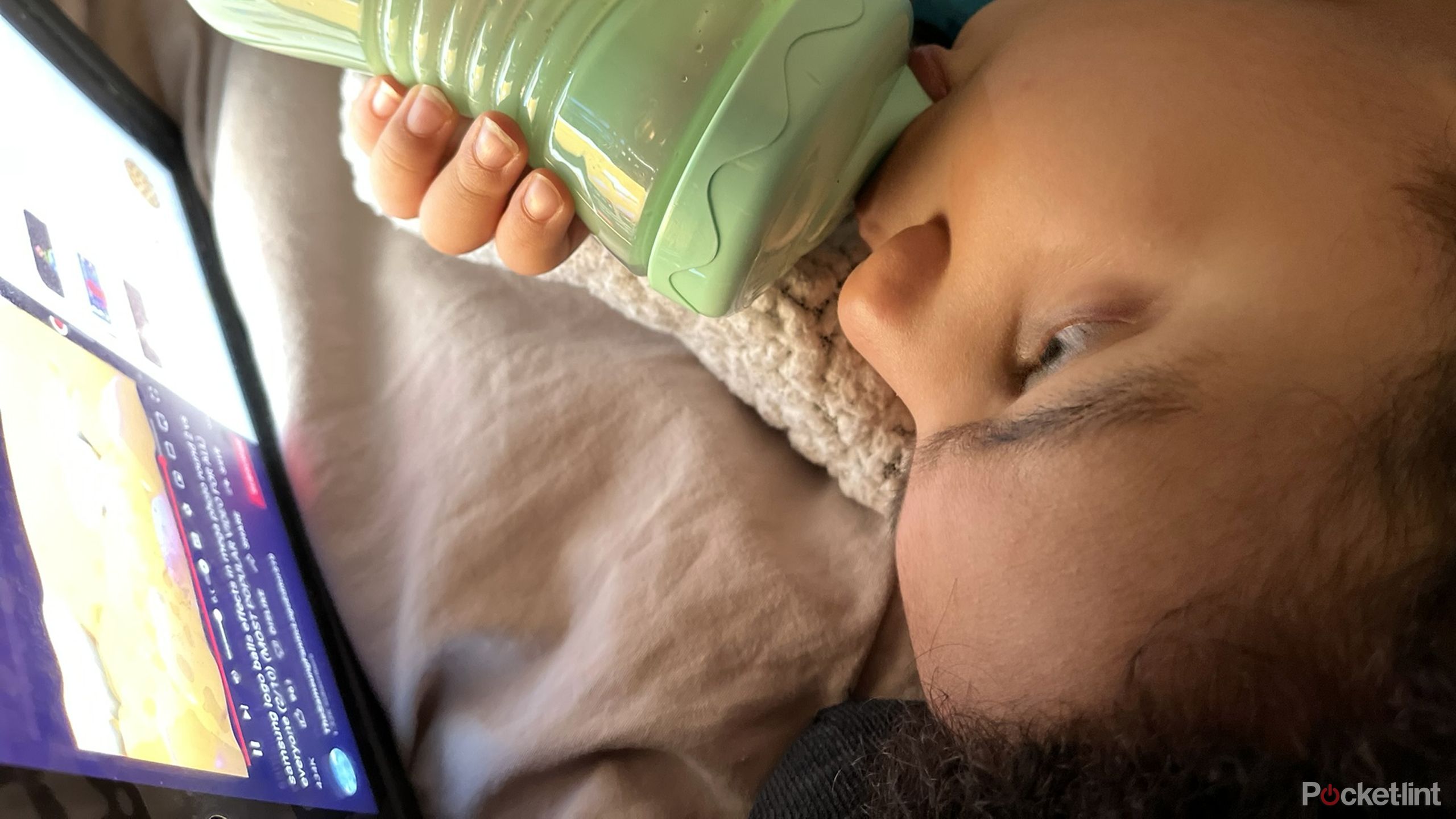 A toddler watching YouTube on an iPad.